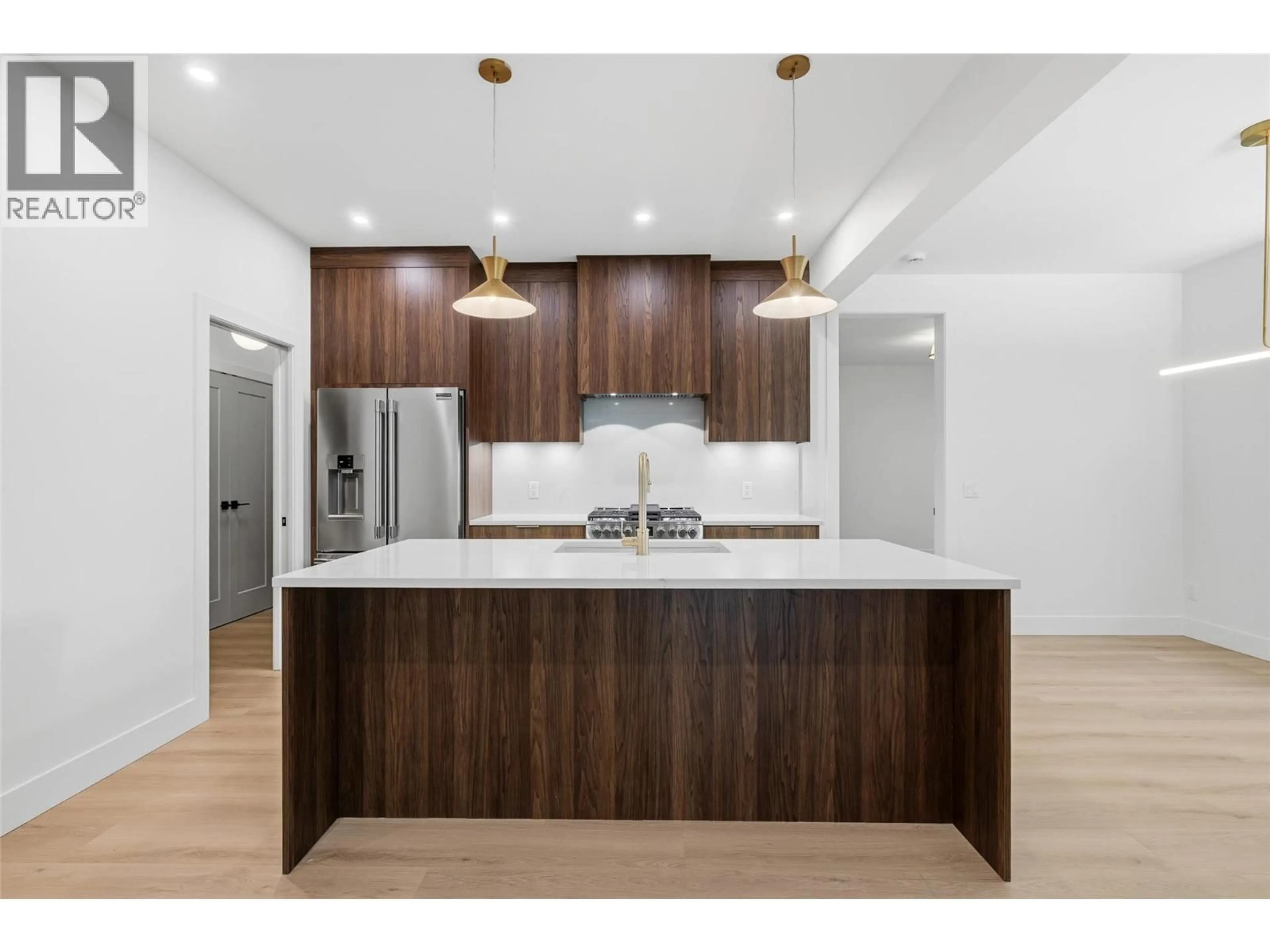 Open concept kitchen, wood/laminate floor for 4222 RUSSO STREET, Kelowna British Columbia V1W0C6