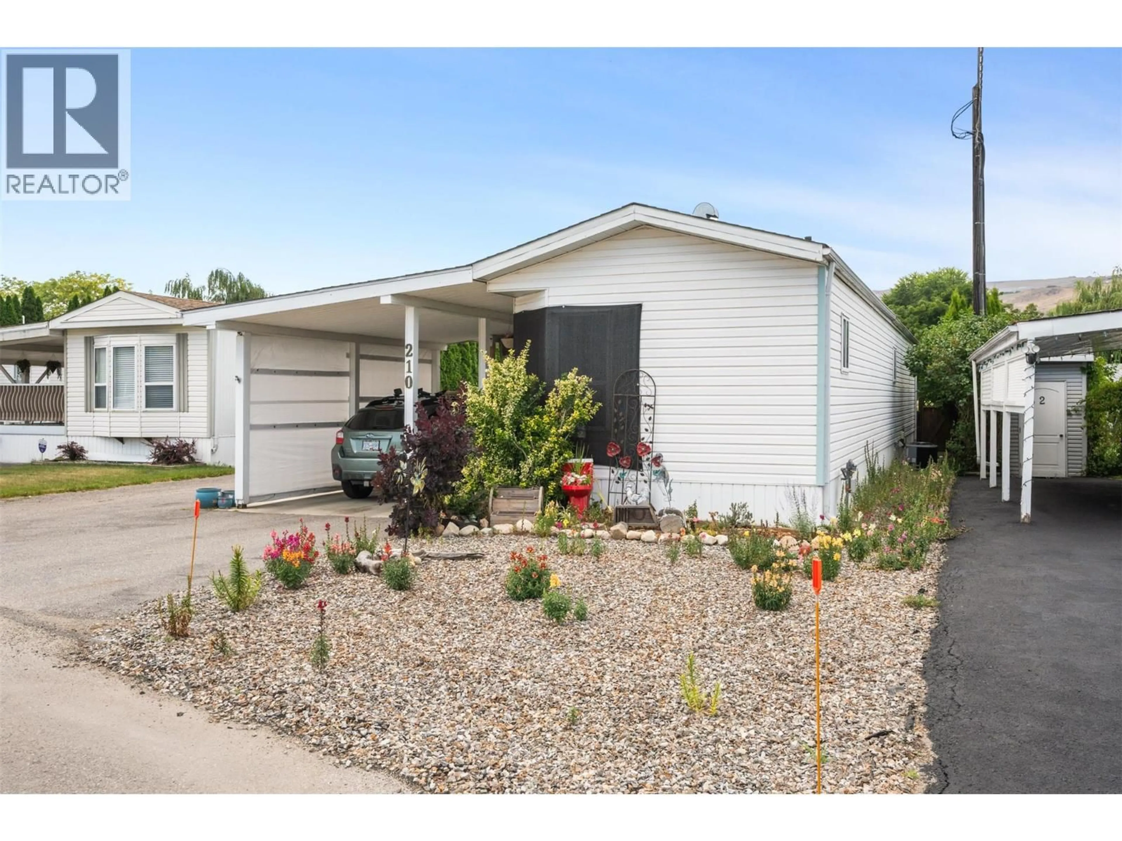 Home with vinyl exterior material, street for 210 - 6710 TRONSON ROAD, Vernon British Columbia V1H1X6