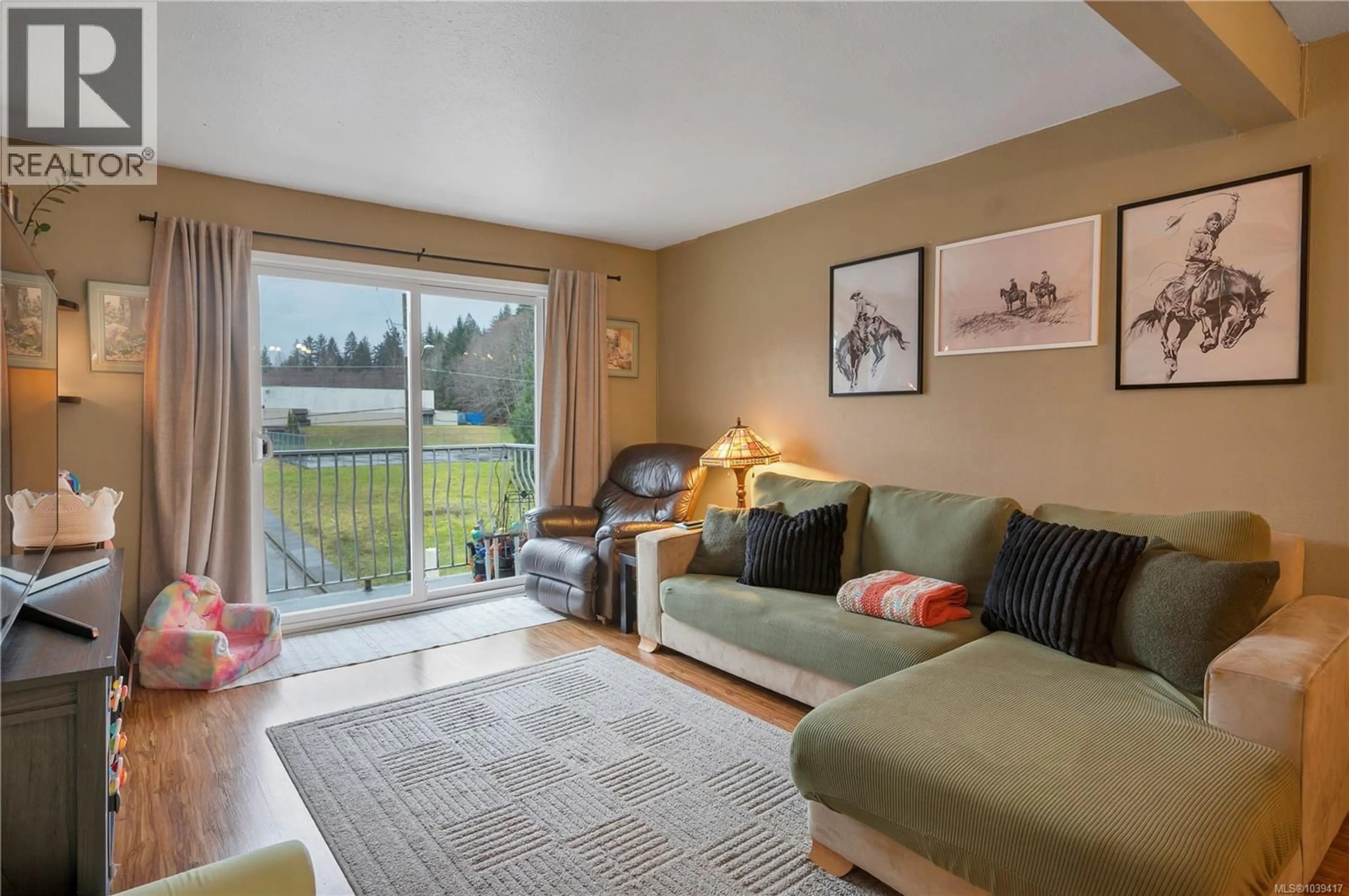 Living room with furniture, wood/laminate floor for 307 - 611 MACMILLAN DRIVE, Sayward British Columbia V0P1R0