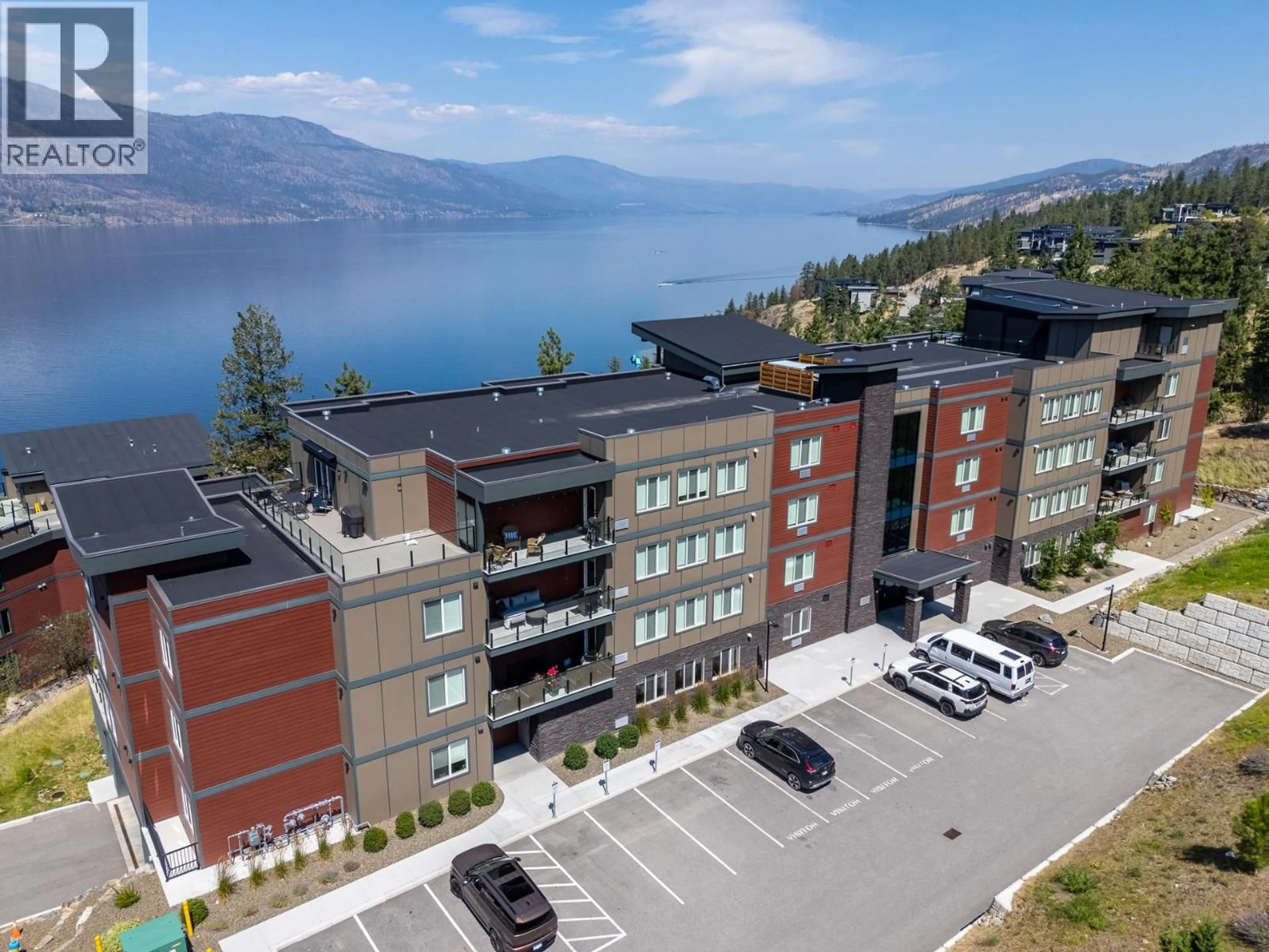A pic from outside/outdoor area/front of a property/back of a property/a pic from drone, water/lake/river/ocean view for 103 - 3434 MCKINLEY BEACH DRIVE, Kelowna British Columbia V1V0H3