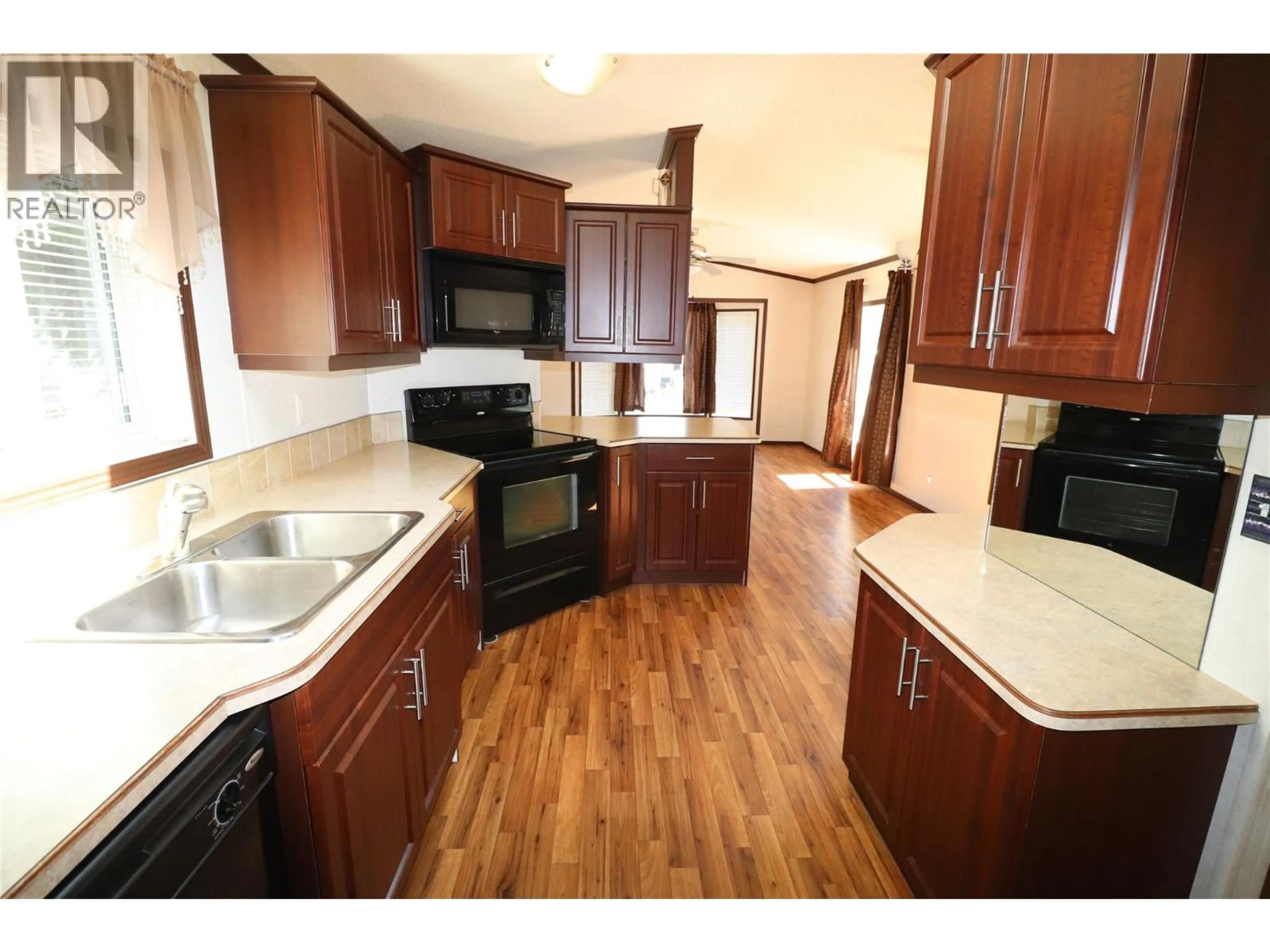 Open concept kitchen, wood/laminate floor for 57 - 500 16TH AVENUE, Genelle British Columbia V0G1G0