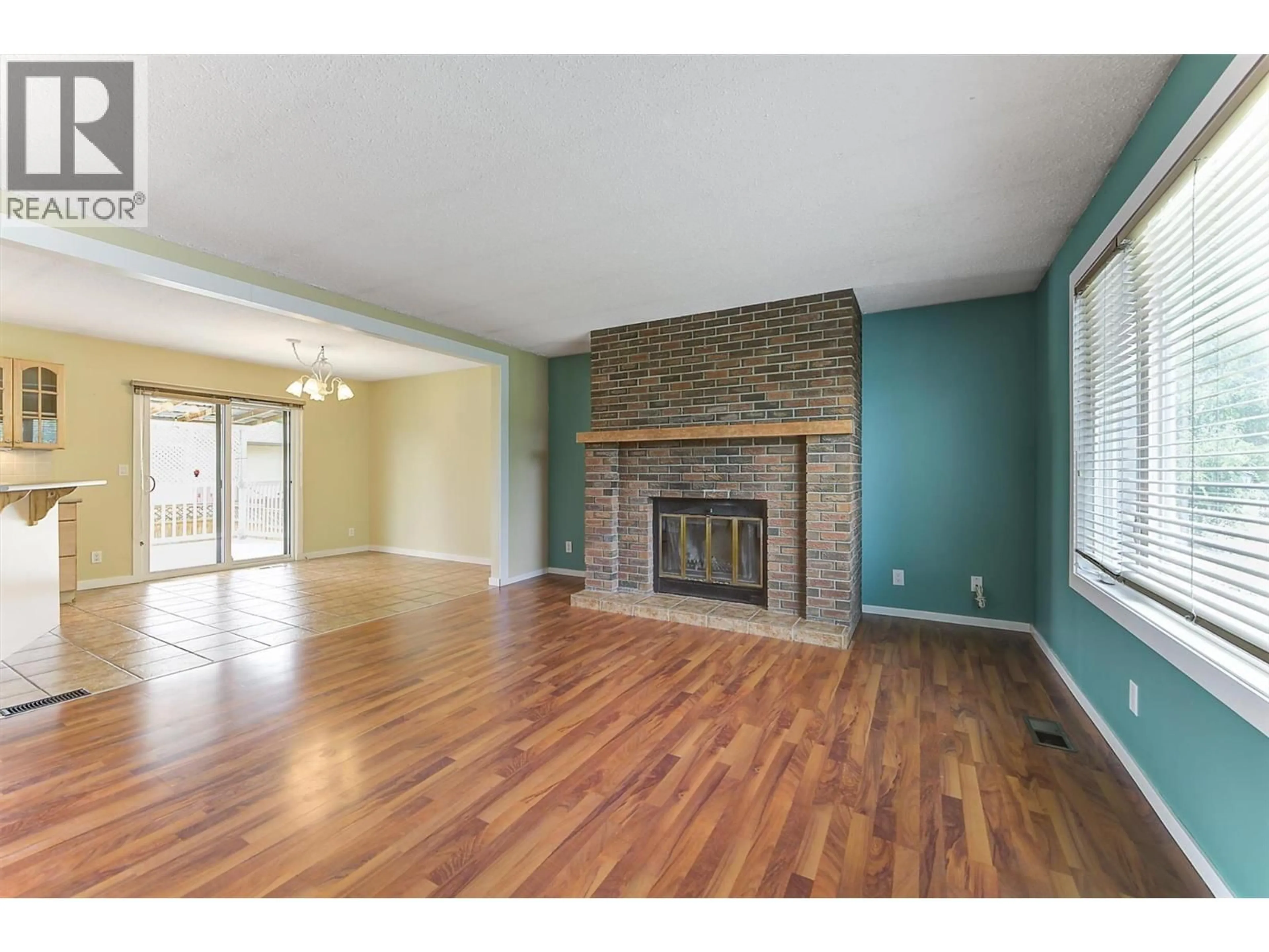Living room with furniture, wood/laminate floor for 1392 ELM STREET, Kelowna British Columbia V1Y3W6