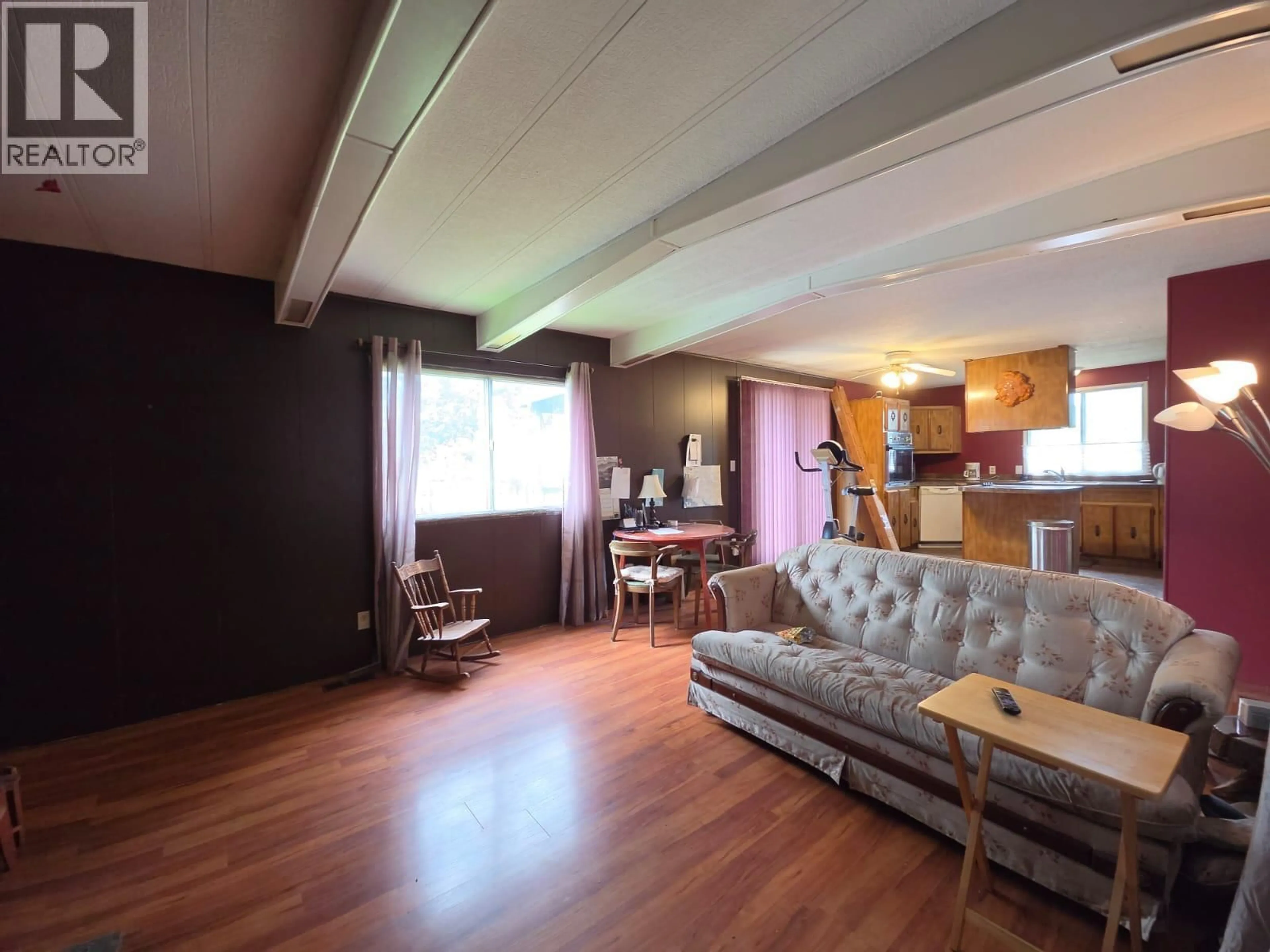 Living room with furniture, wood/laminate floor for 5293 44 STREET SOUTHEAST, Chetwynd British Columbia V0C1J0