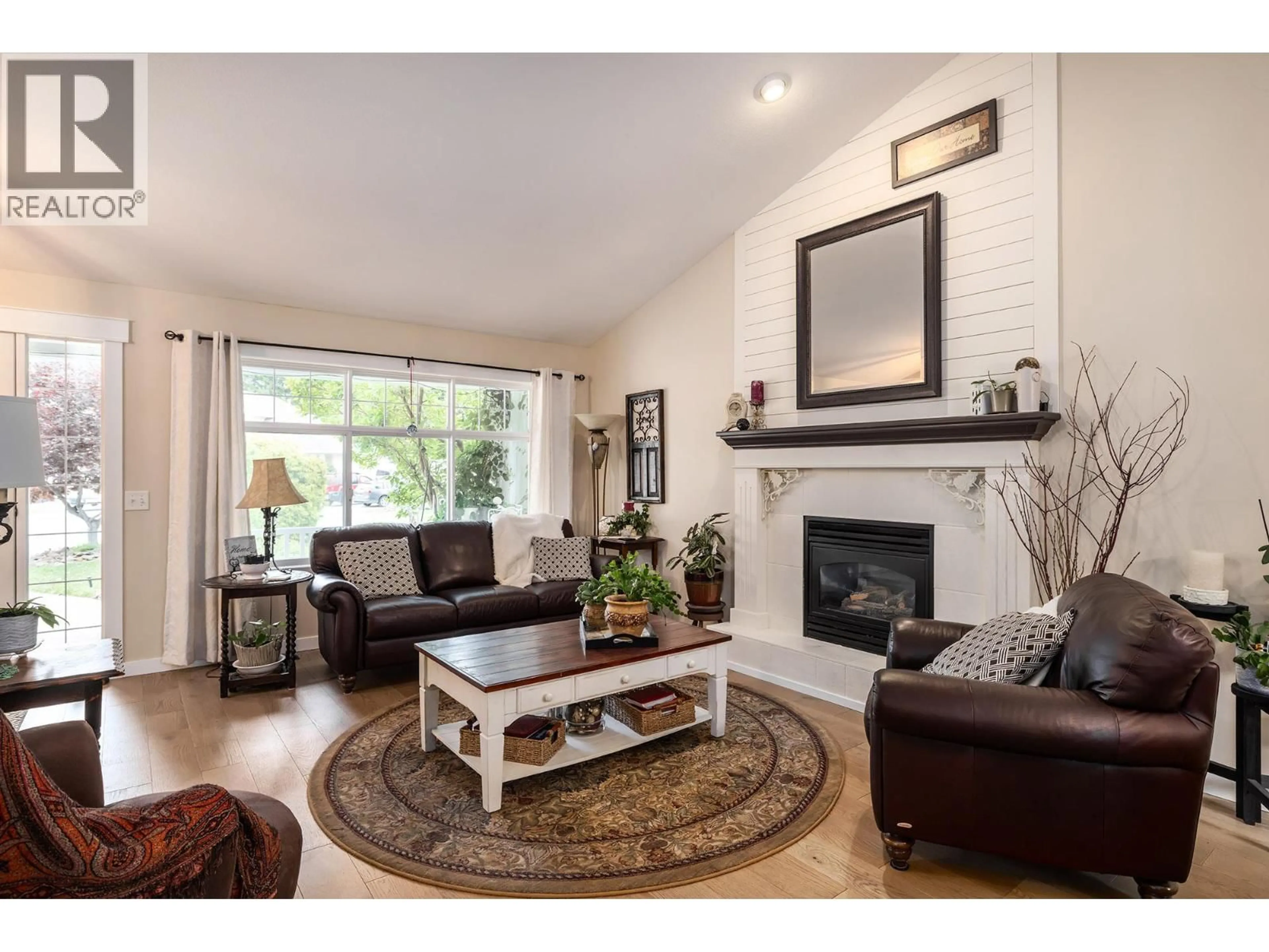 Living room with furniture, wood/laminate floor for 140 - 2220 SHANNON RIDGE DRIVE, West Kelowna British Columbia V4T2T6