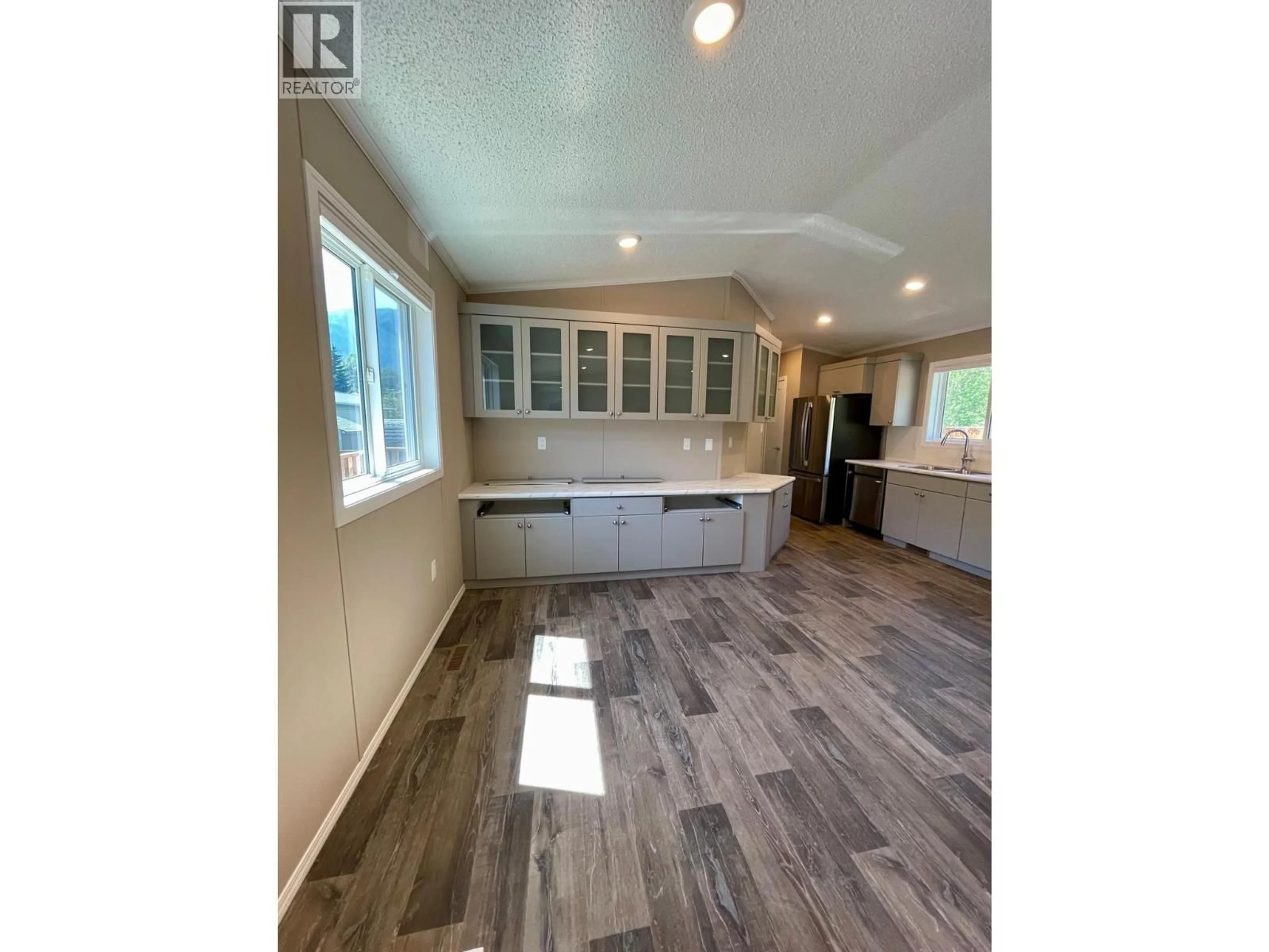 Open concept kitchen, wood/laminate floor for 47 - 100 ASPEN DRIVE, Sparwood British Columbia V0B2G0