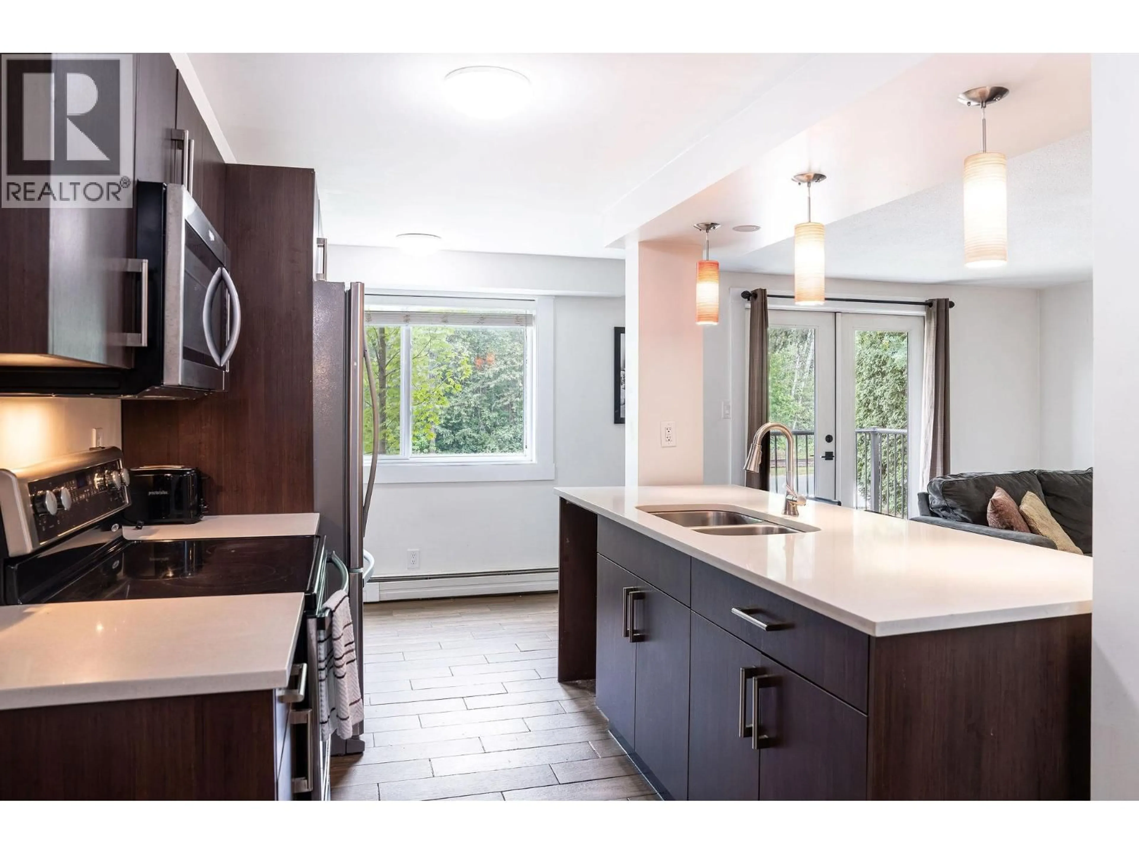 Open concept kitchen, ceramic/tile floor for 104 - 1211 VICTORIA ROAD WEST, Revelstoke British Columbia V0E2S0
