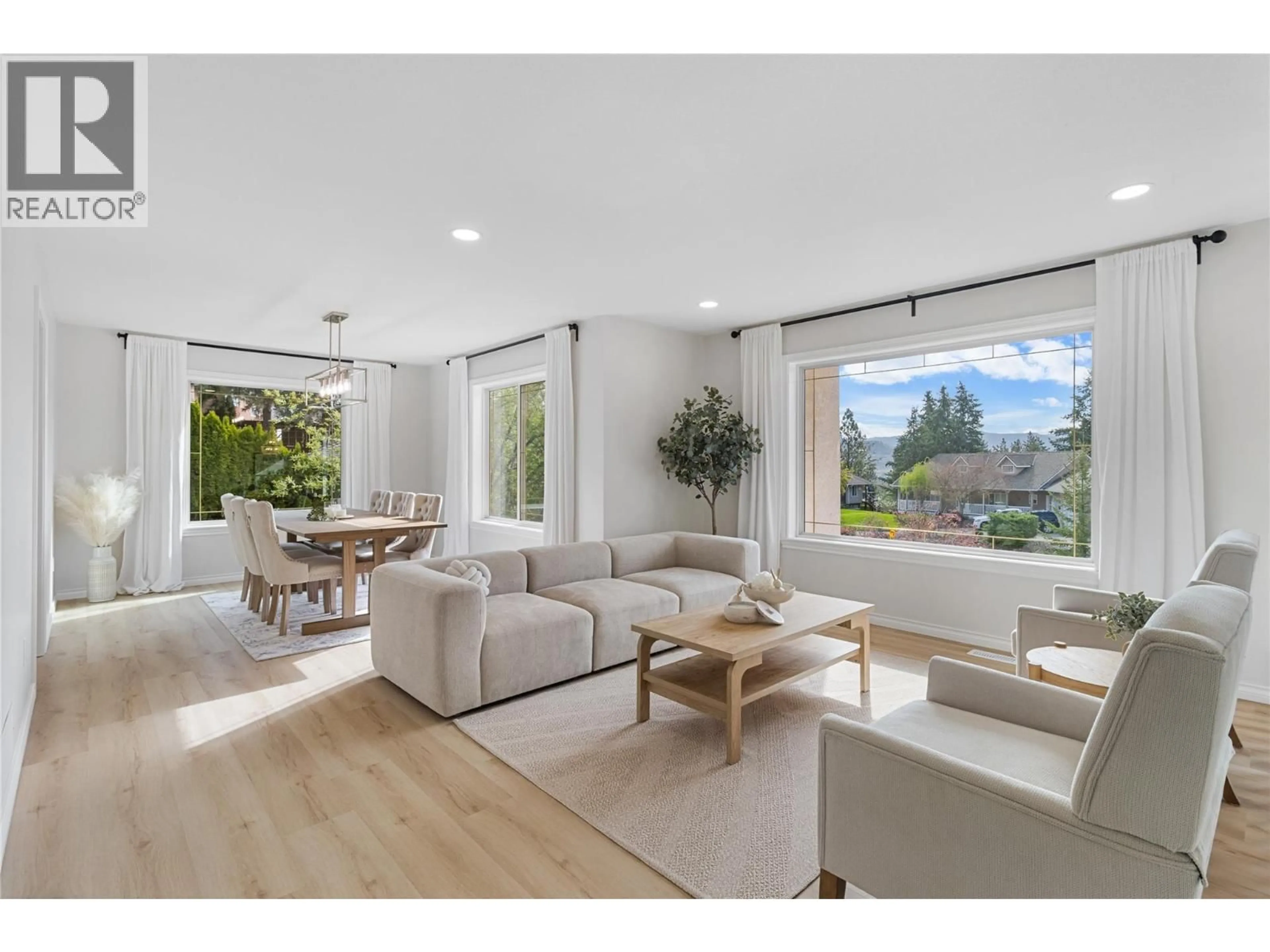 Living room with furniture, wood/laminate floor for 2321 LILLOOET CRESCENT, Kelowna British Columbia V1V1T1
