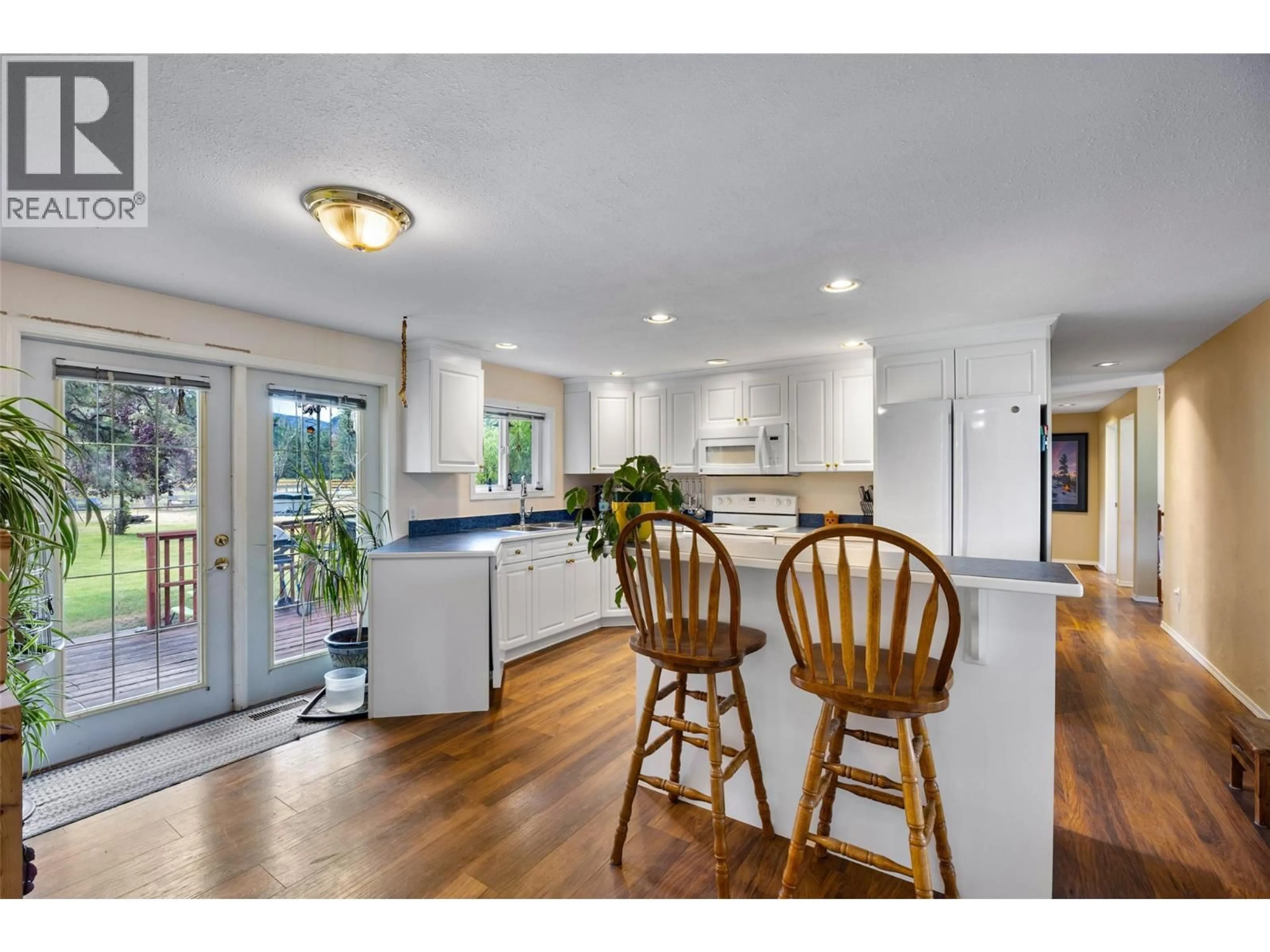 Open concept kitchen, wood/laminate floor for 6572 BECKER ROAD, Westwold British Columbia V0E3B1