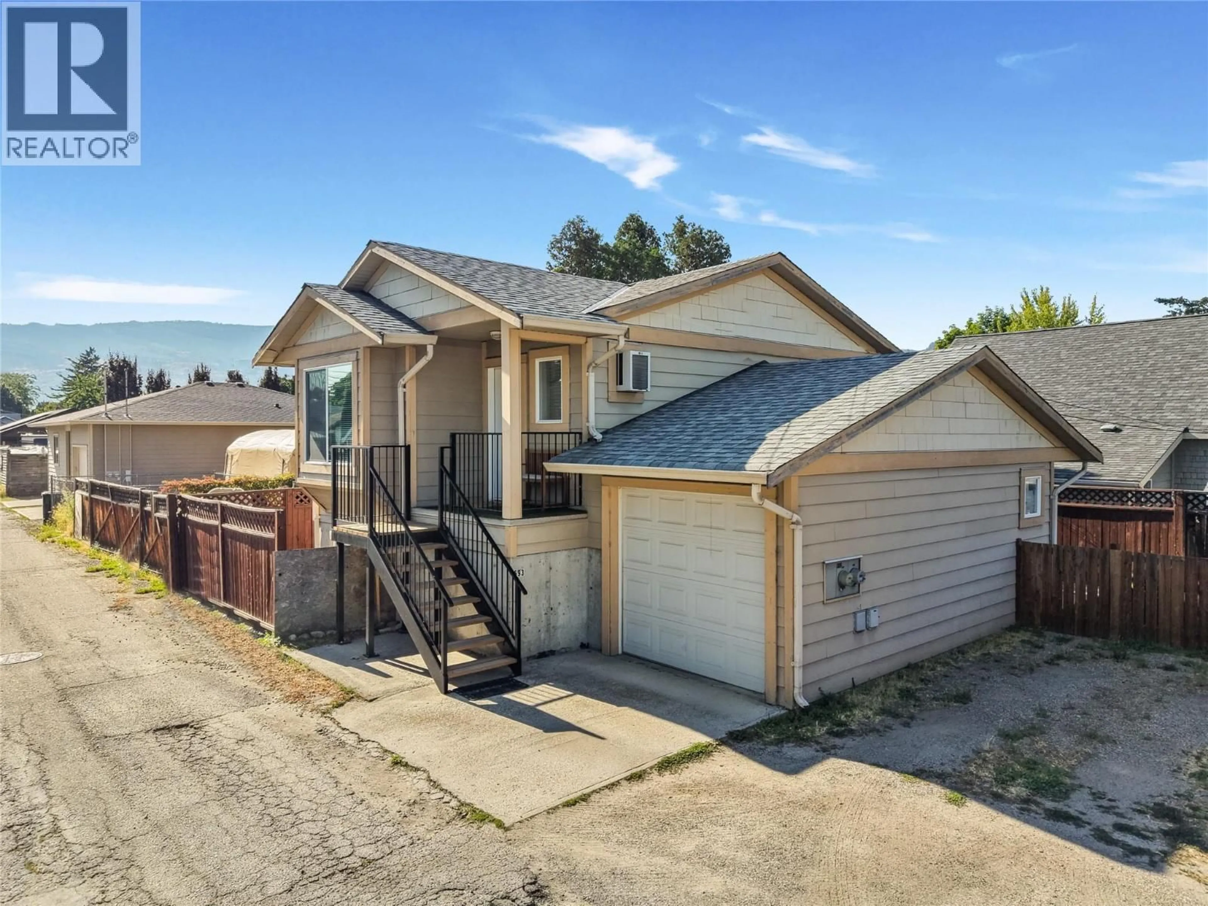 Home with vinyl exterior material, street for 691-693 OKANAGAN BOULEVARD, Kelowna British Columbia V1Y7L2