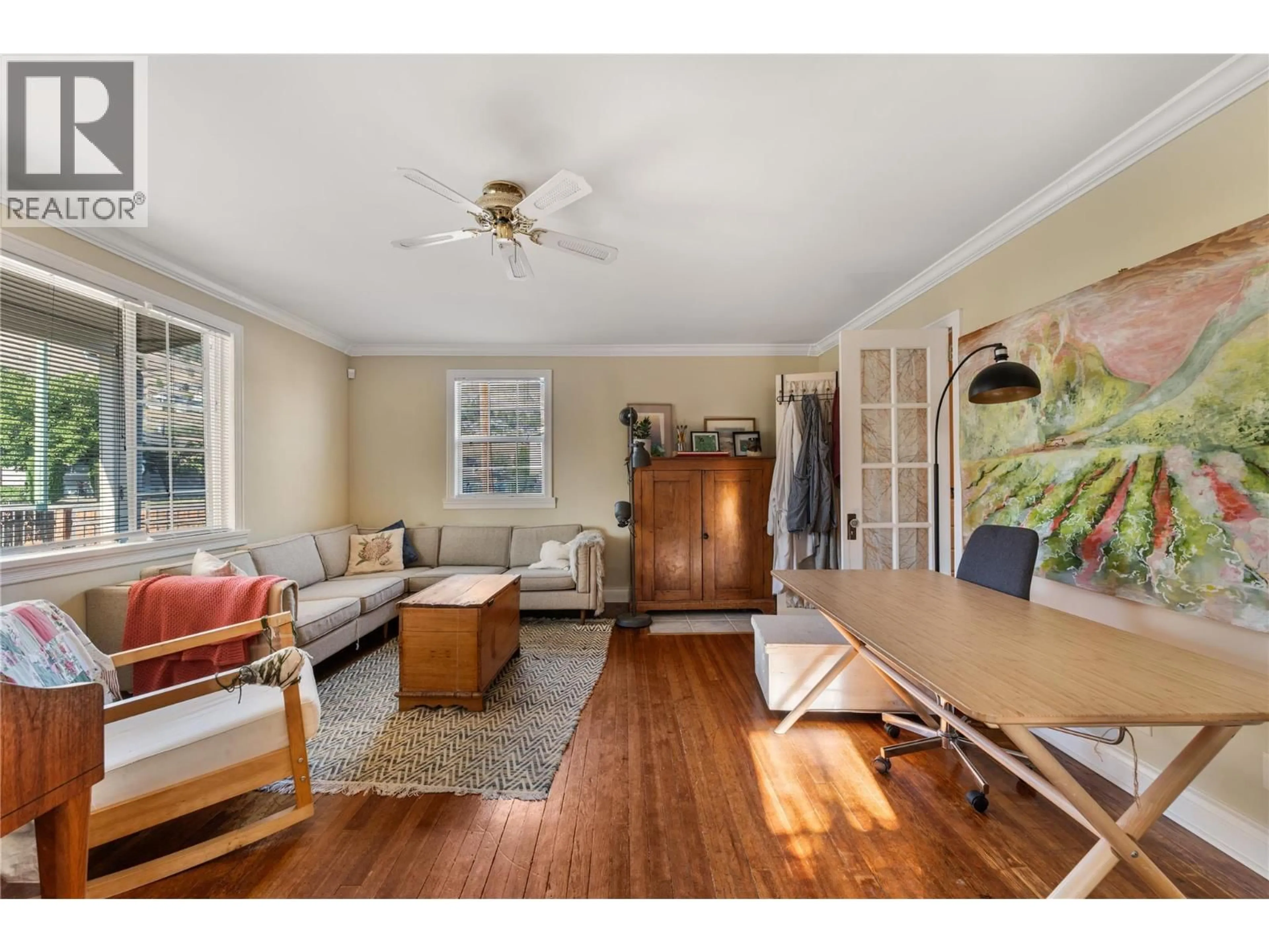 Living room with furniture, wood/laminate floor for 691-693 OKANAGAN BOULEVARD, Kelowna British Columbia V1Y7L2