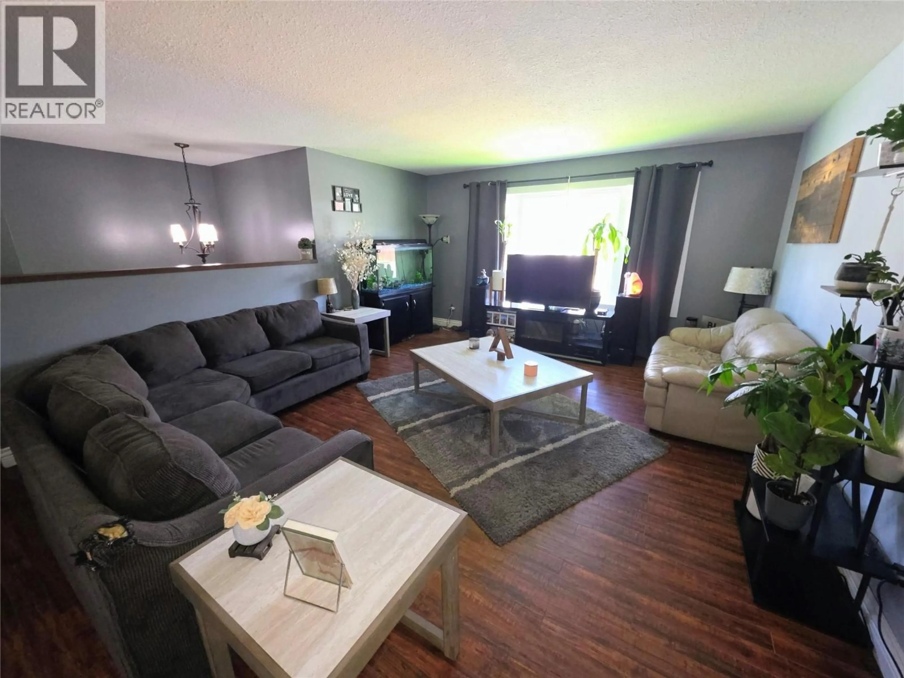 Living room with furniture, wood/laminate floor for 1837 COLUMBIA GARDENS ROAD, Fruitvale British Columbia V0G1L0