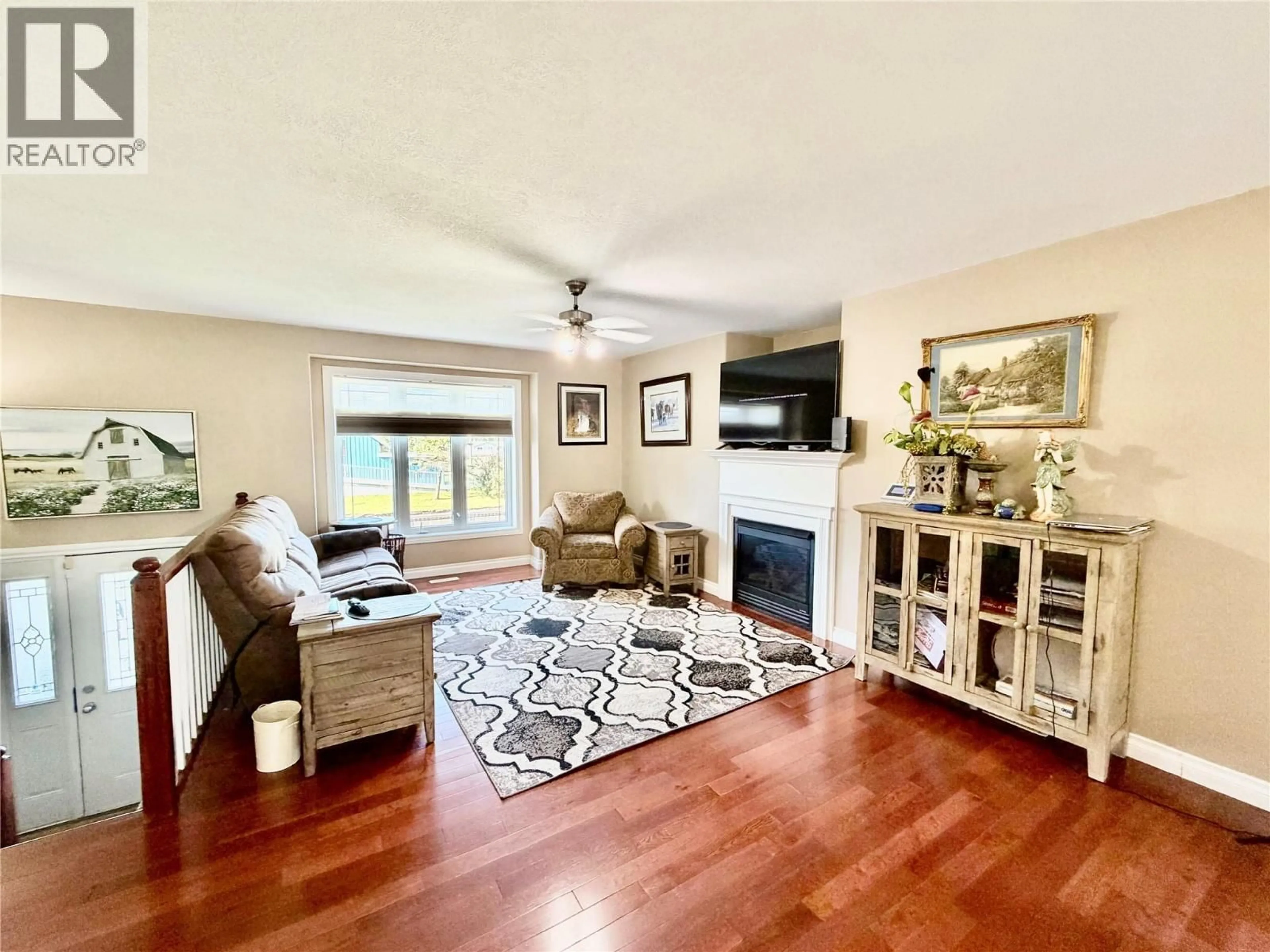 Living room with furniture, wood/laminate floor for 1801 109 AVENUE, Dawson Creek British Columbia V1G2V6