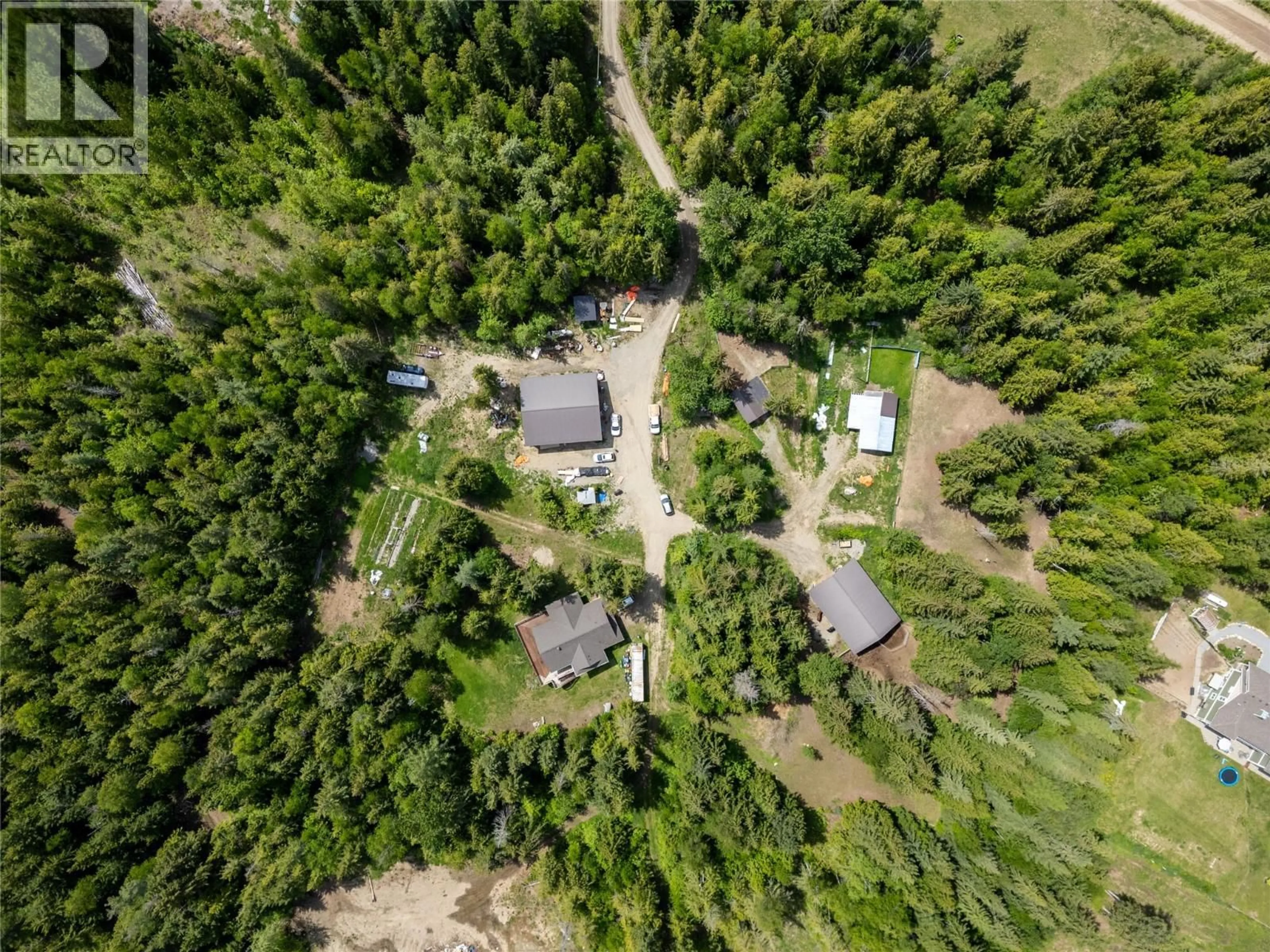 A pic from outside/outdoor area/front of a property/back of a property/a pic from drone, forest/trees view for 63 LIBICH ROAD, Salmon Arm British Columbia V1E2Y1