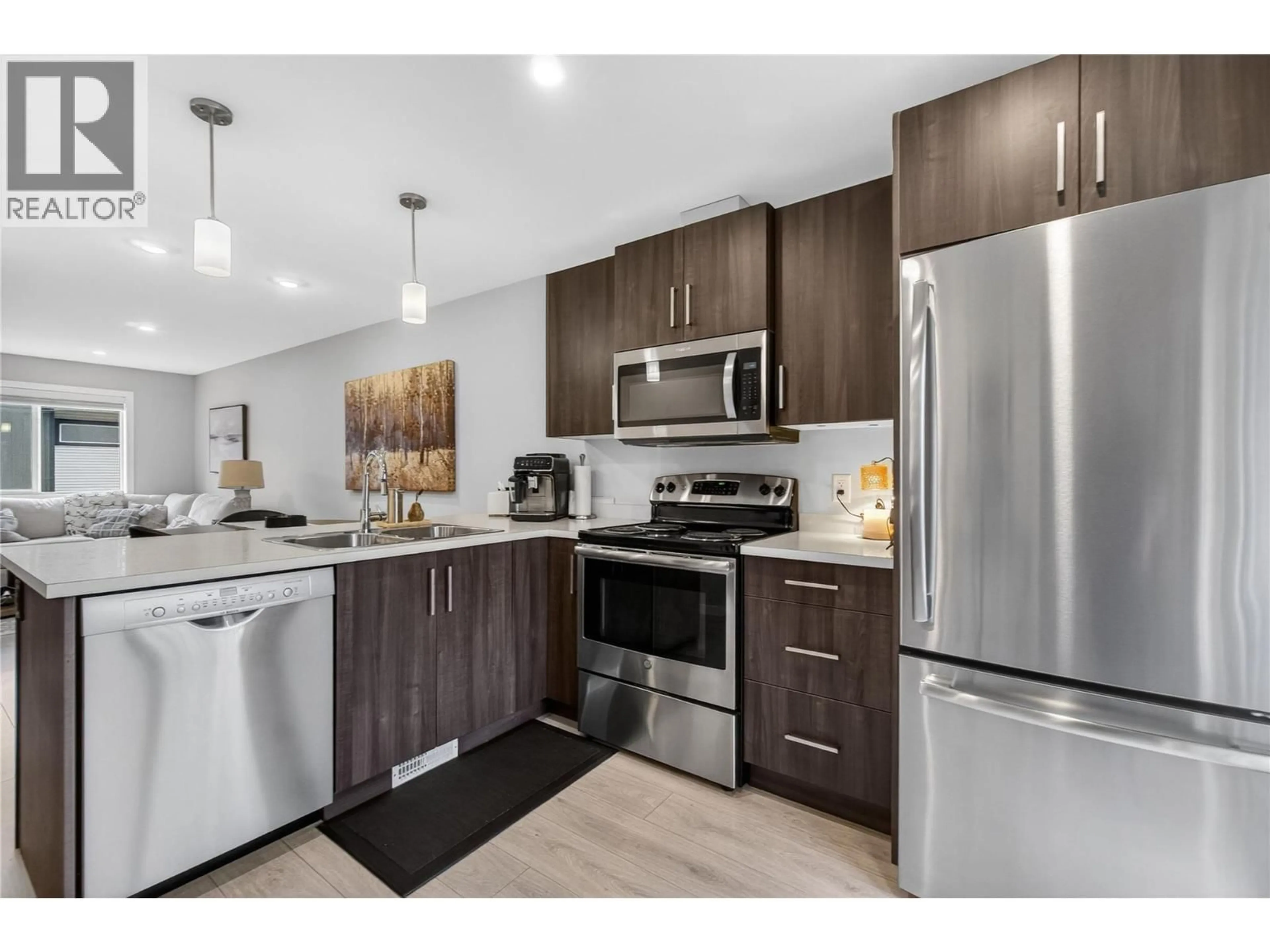 Open concept kitchen, wood/laminate floor for 9 - 2081 11 AVENUE NORTHEAST, Salmon Arm British Columbia V1E0G1