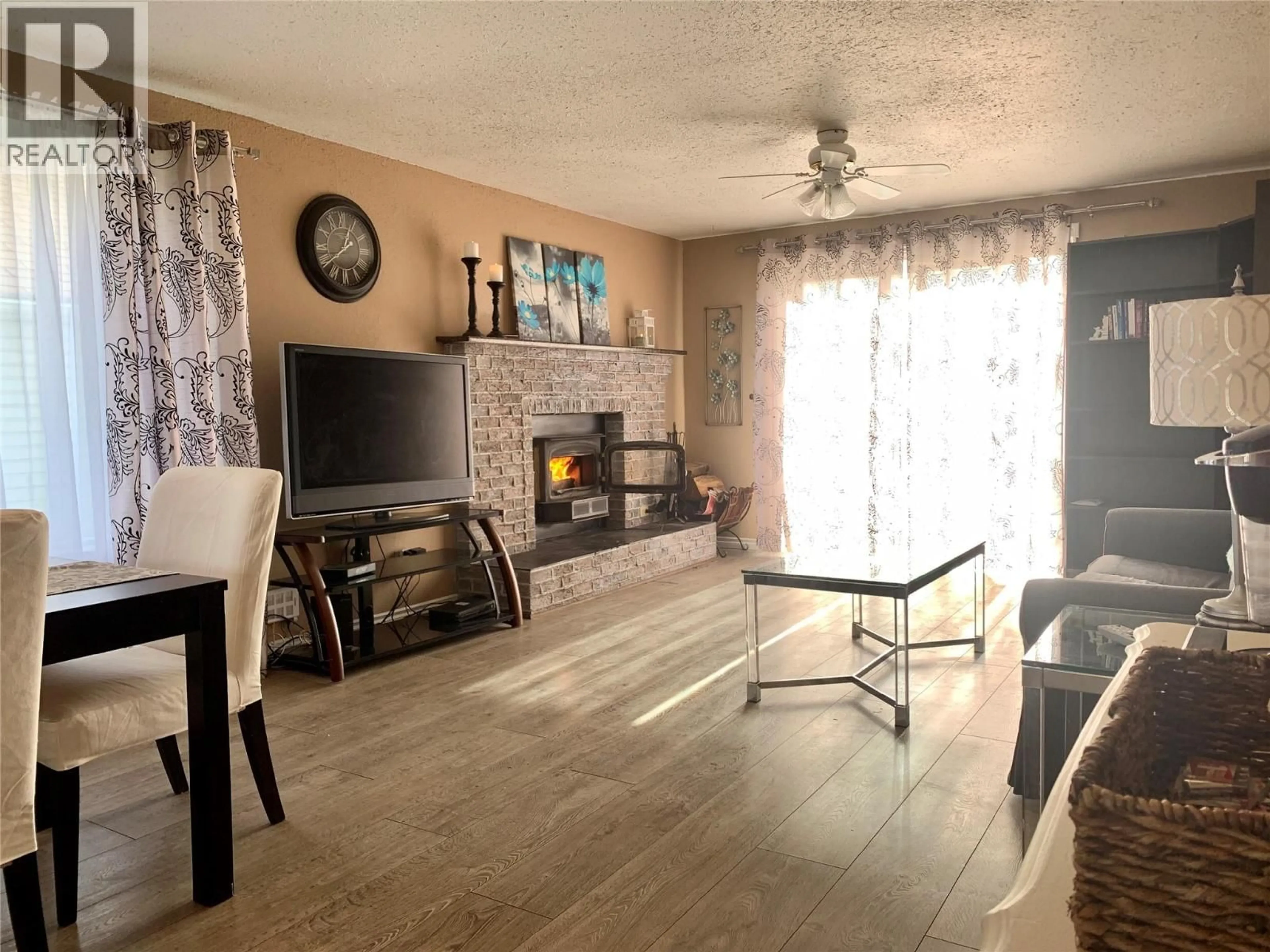Living room with furniture, wood/laminate floor for 1329 108 AVENUE, Dawson Creek British Columbia V1G4J2