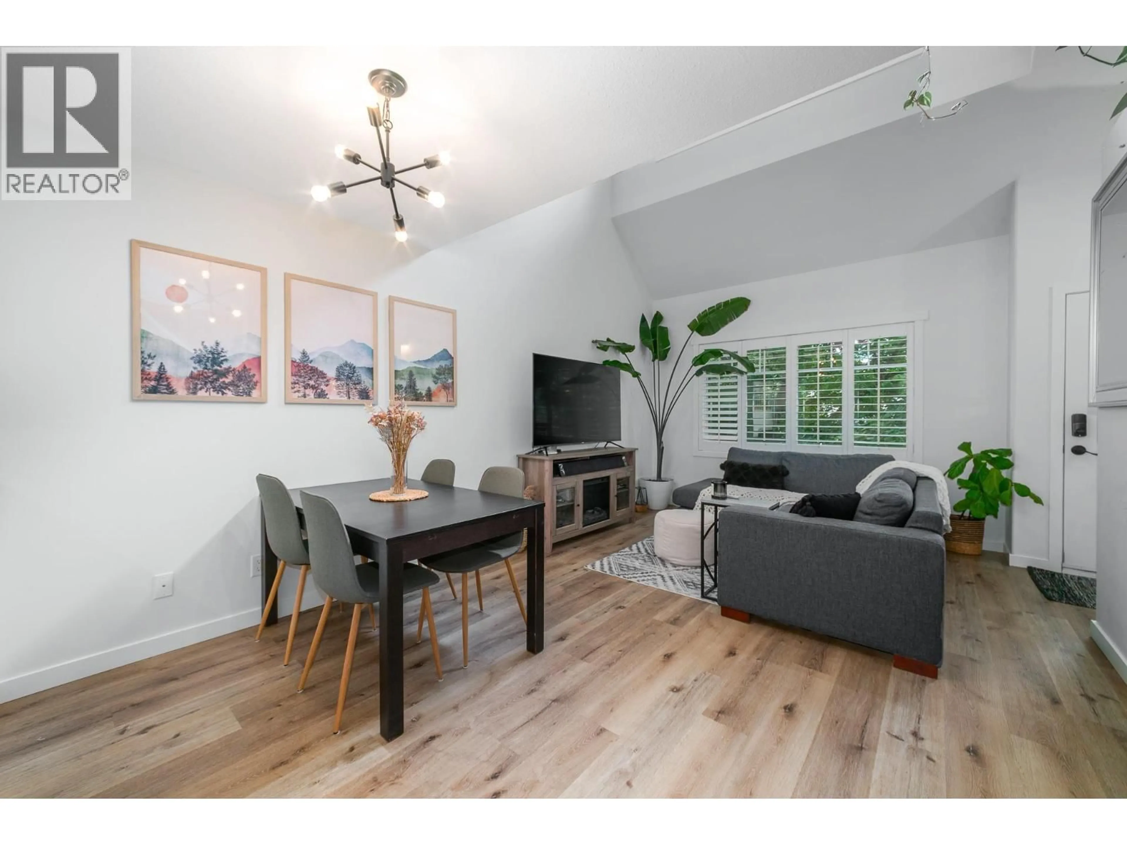 Living room with furniture, wood/laminate floor for 211 - 1390 DILWORTH CRESCENT, Kelowna British Columbia V1Y4M5
