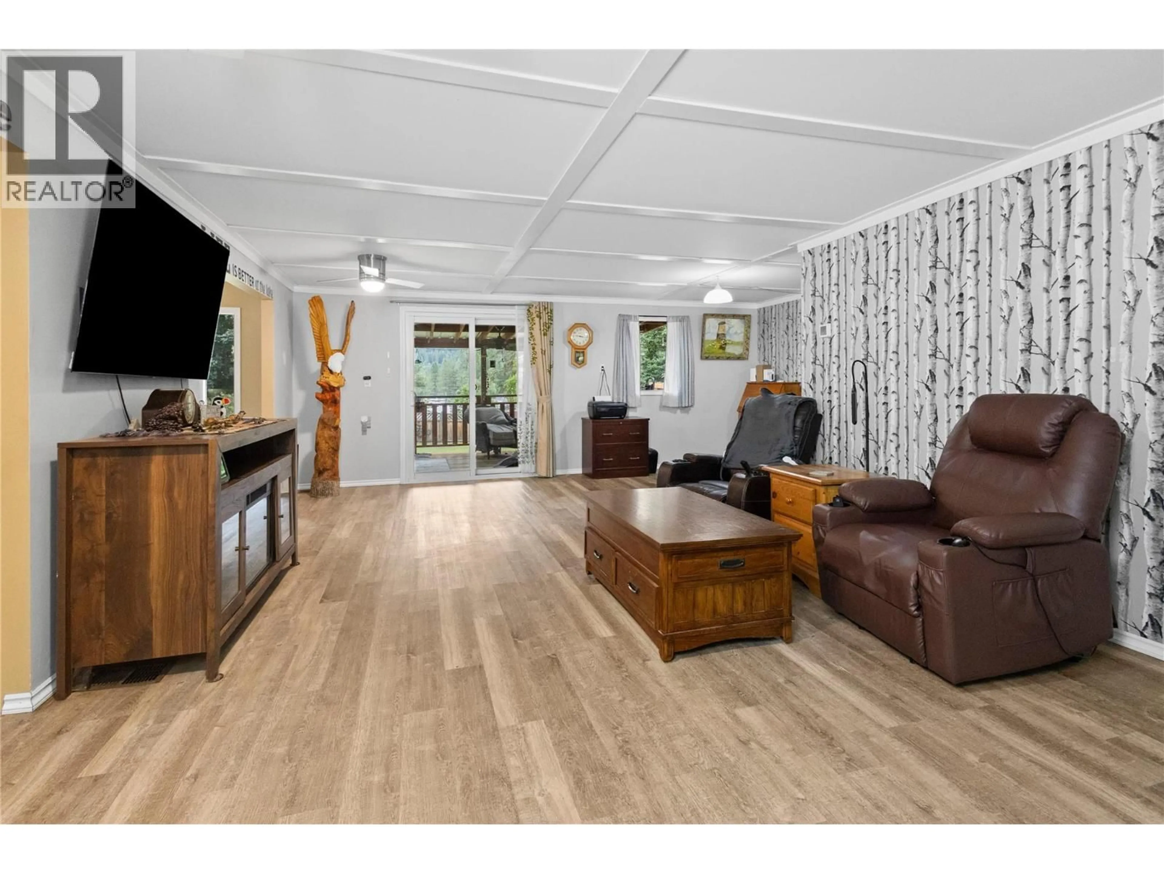 Living room with furniture, wood/laminate floor for 1538 BURGER ROAD, Christina Lake British Columbia V0H1E0