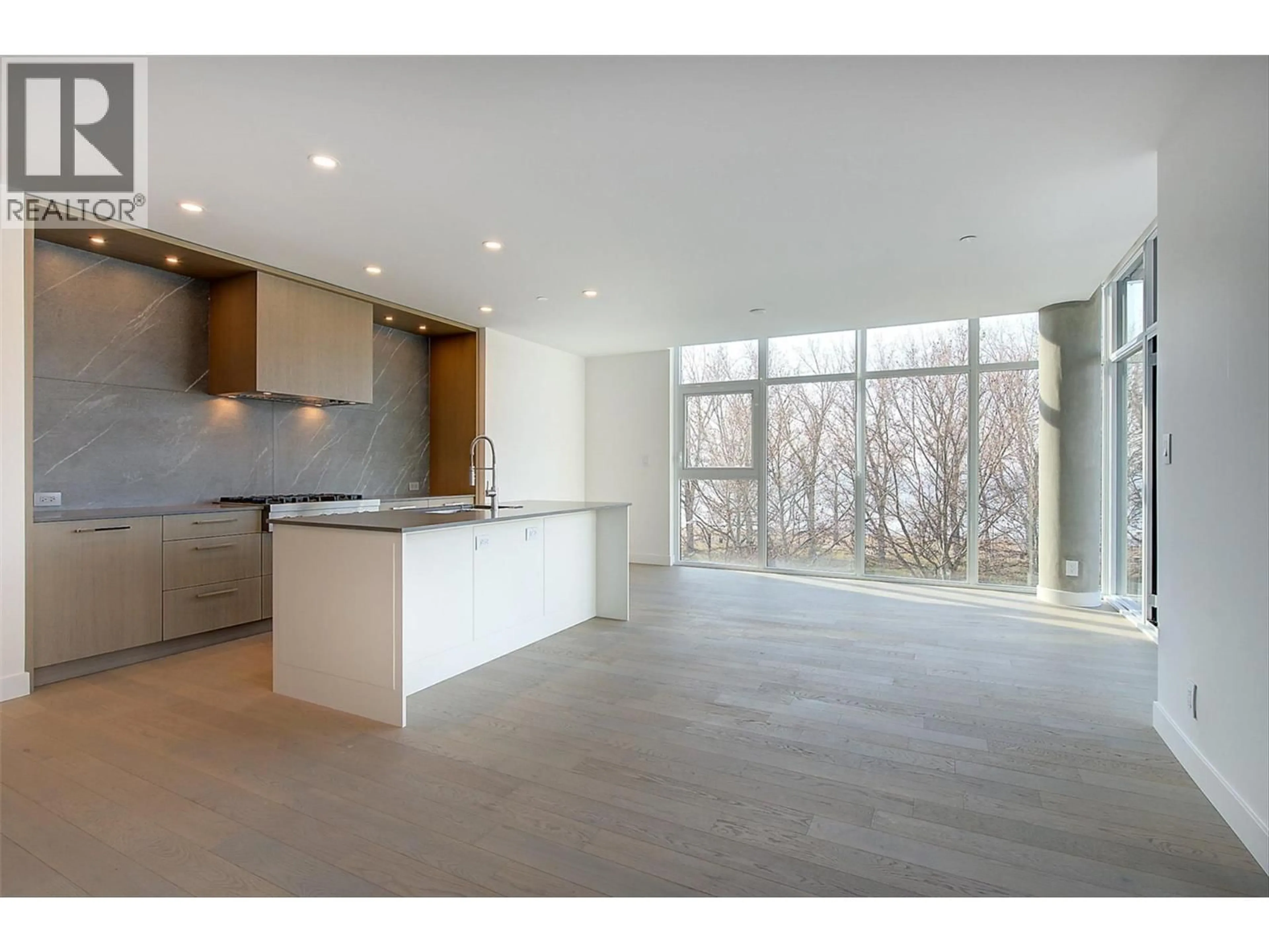 Open concept kitchen, cement floor for 416 - 3389 LAKESHORE ROAD, Kelowna British Columbia V1W0G5