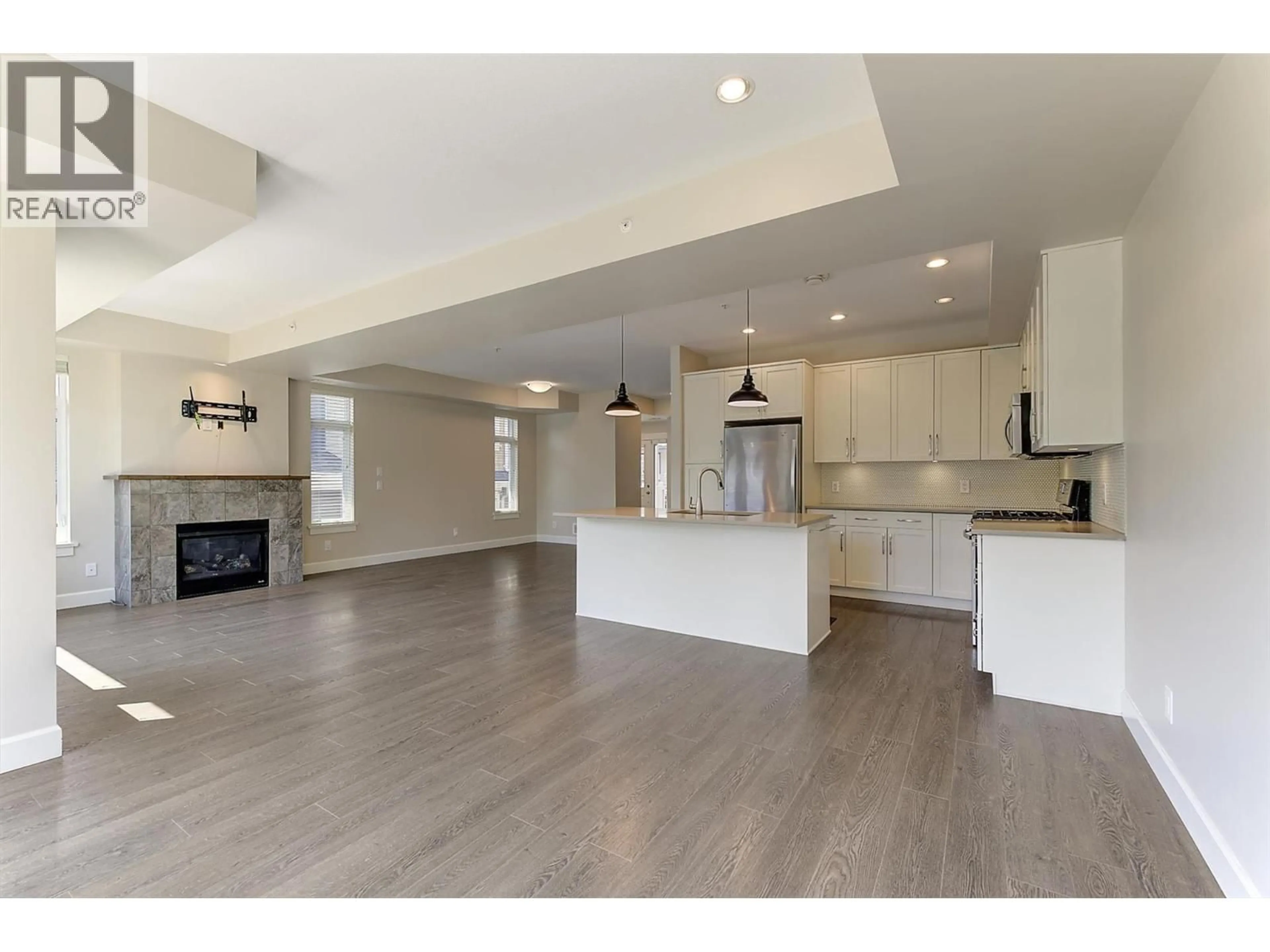 Open concept kitchen, wood/laminate floor for 11 - 12850 STILLWATER COURT, Lake Country British Columbia V4V2S9