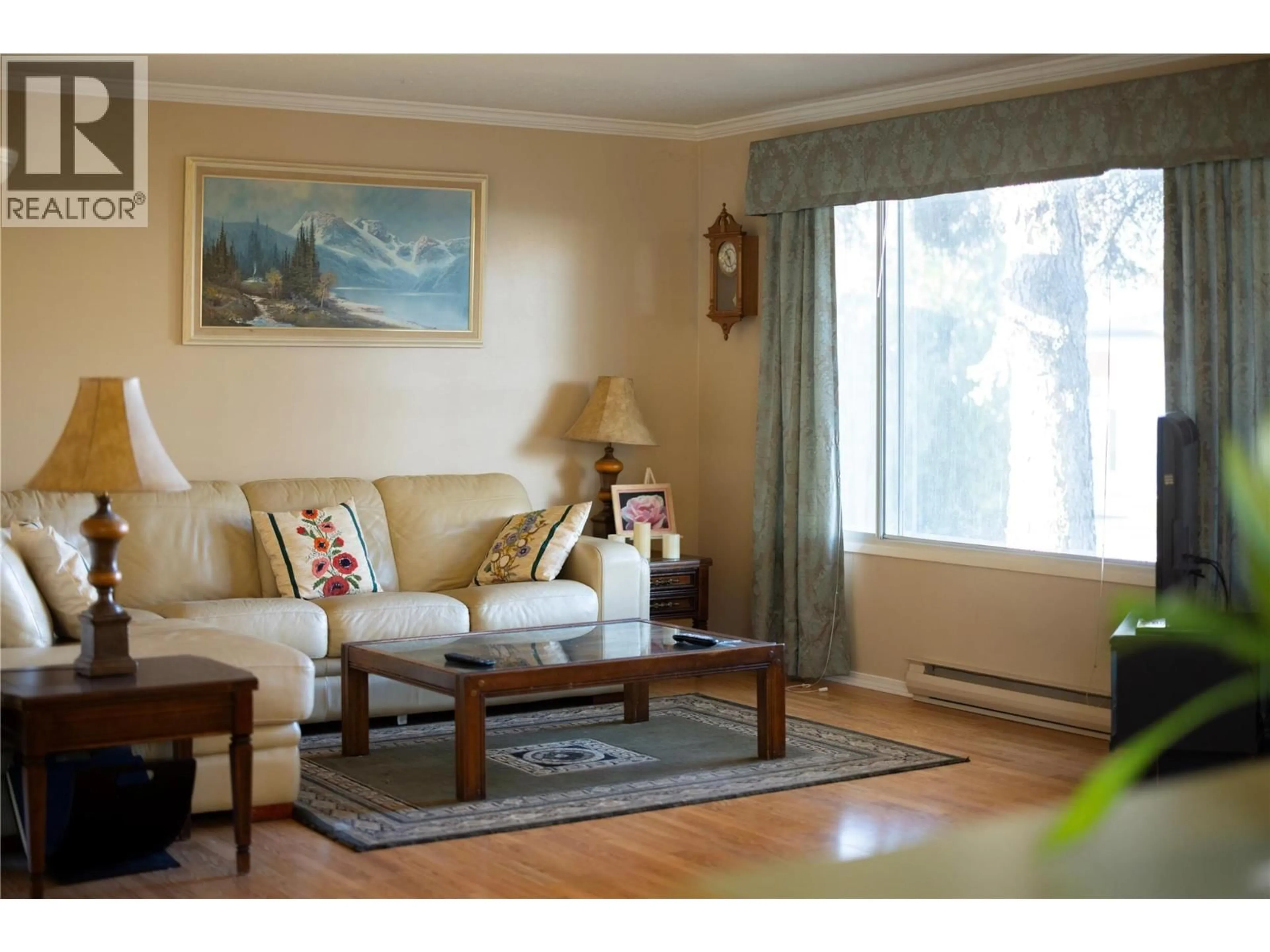 Living room with furniture, wood/laminate floor for 1607 45 STREET, Vernon British Columbia V1T7P9