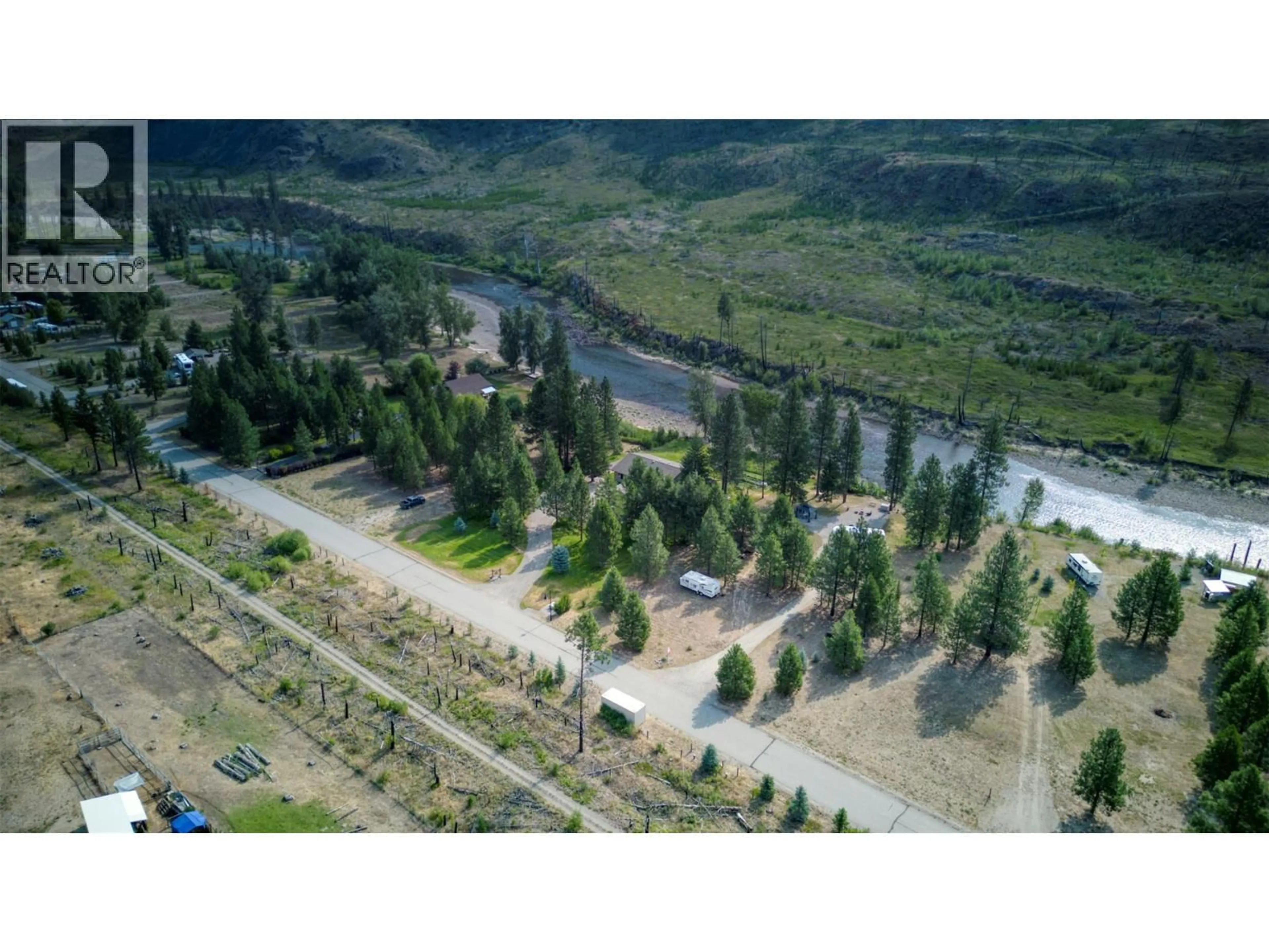 A pic from outside/outdoor area/front of a property/back of a property/a pic from drone, forest/trees view for 212 VINTAGE LANE, Rock Creek British Columbia V0H1Y0