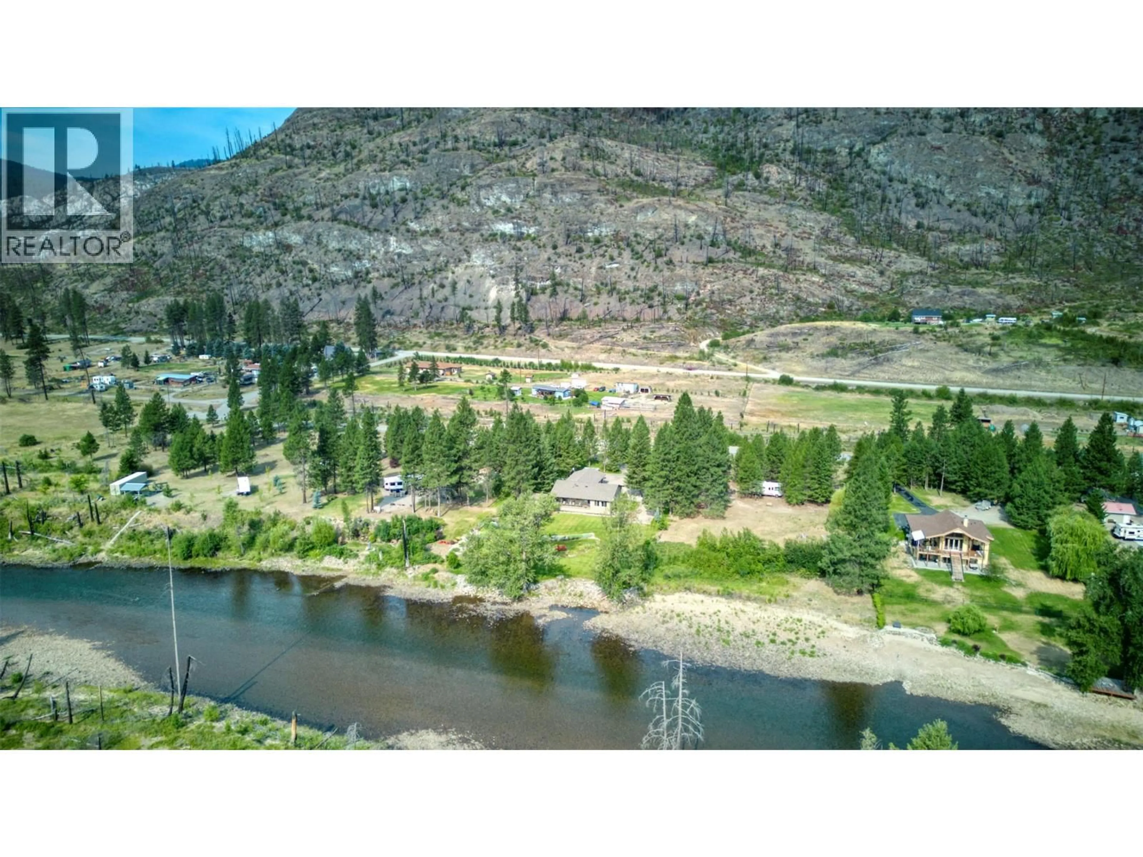 A pic from outside/outdoor area/front of a property/back of a property/a pic from drone, water/lake/river/ocean view for 212 VINTAGE LANE, Rock Creek British Columbia V0H1Y0