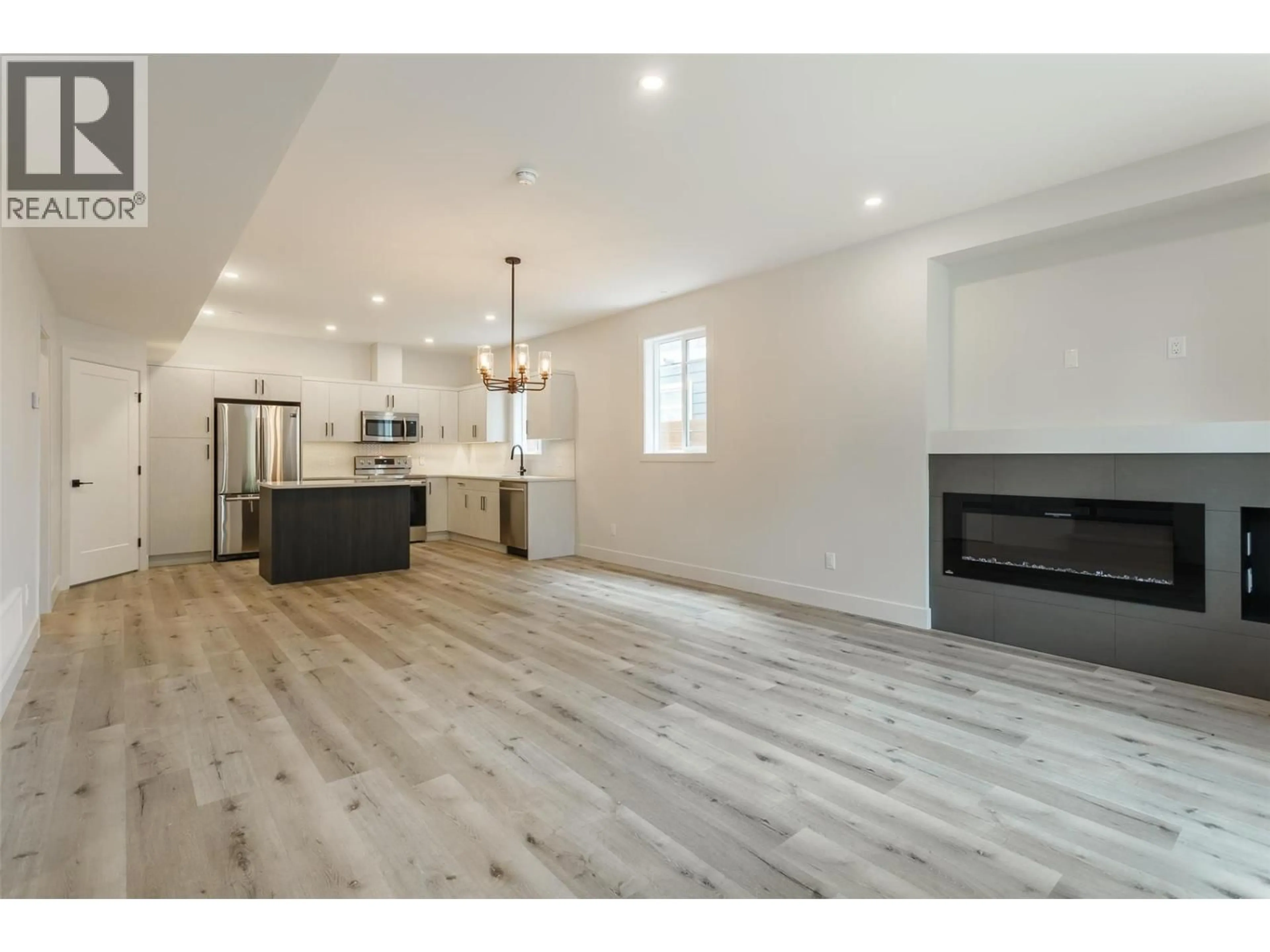 Open concept kitchen, wood/laminate floor for 949 STOCKWELL AVENUE, Kelowna British Columbia V1Y6W3