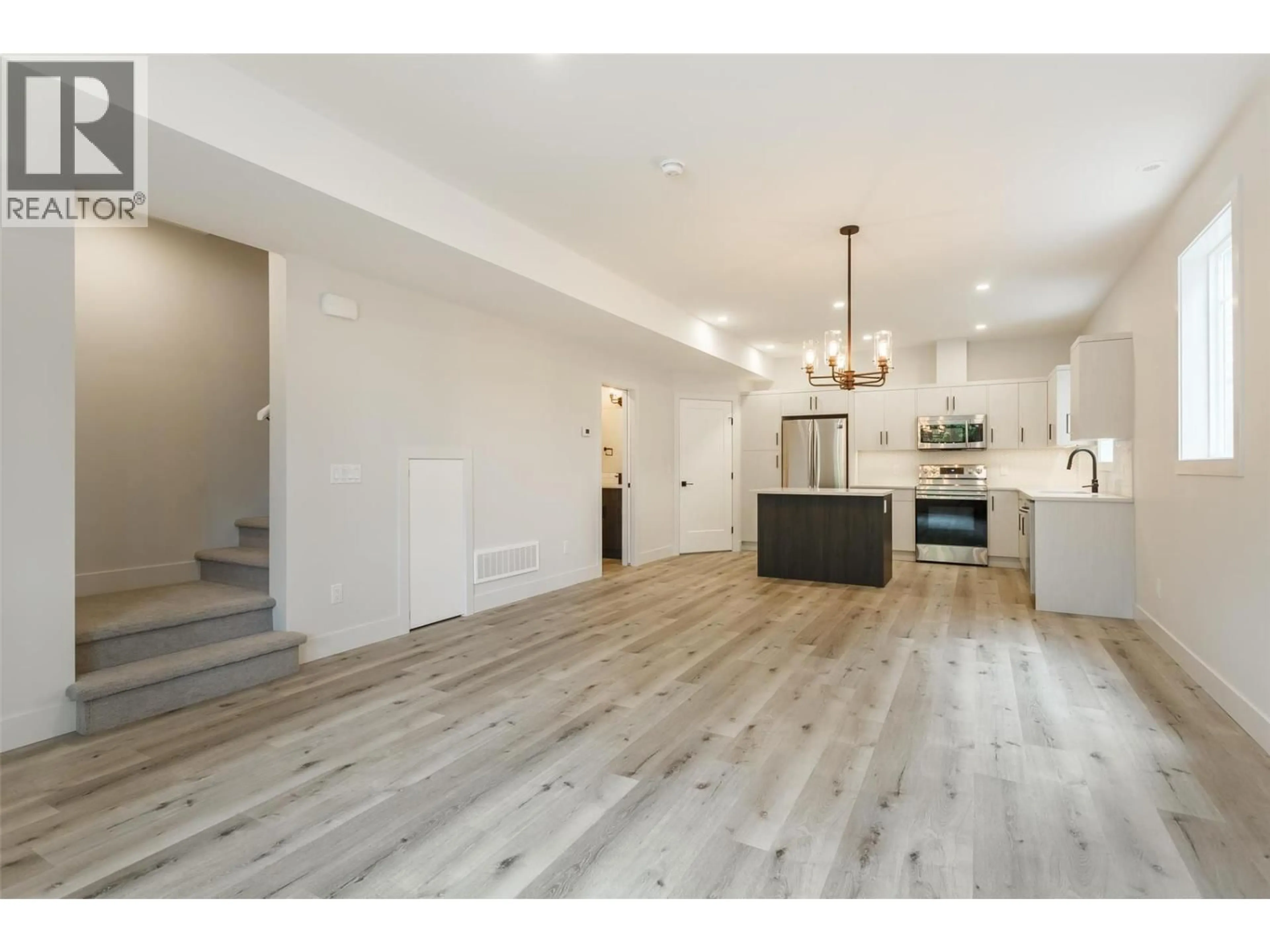 Open concept kitchen, wood/laminate floor for 949 STOCKWELL AVENUE, Kelowna British Columbia V1Y6W3