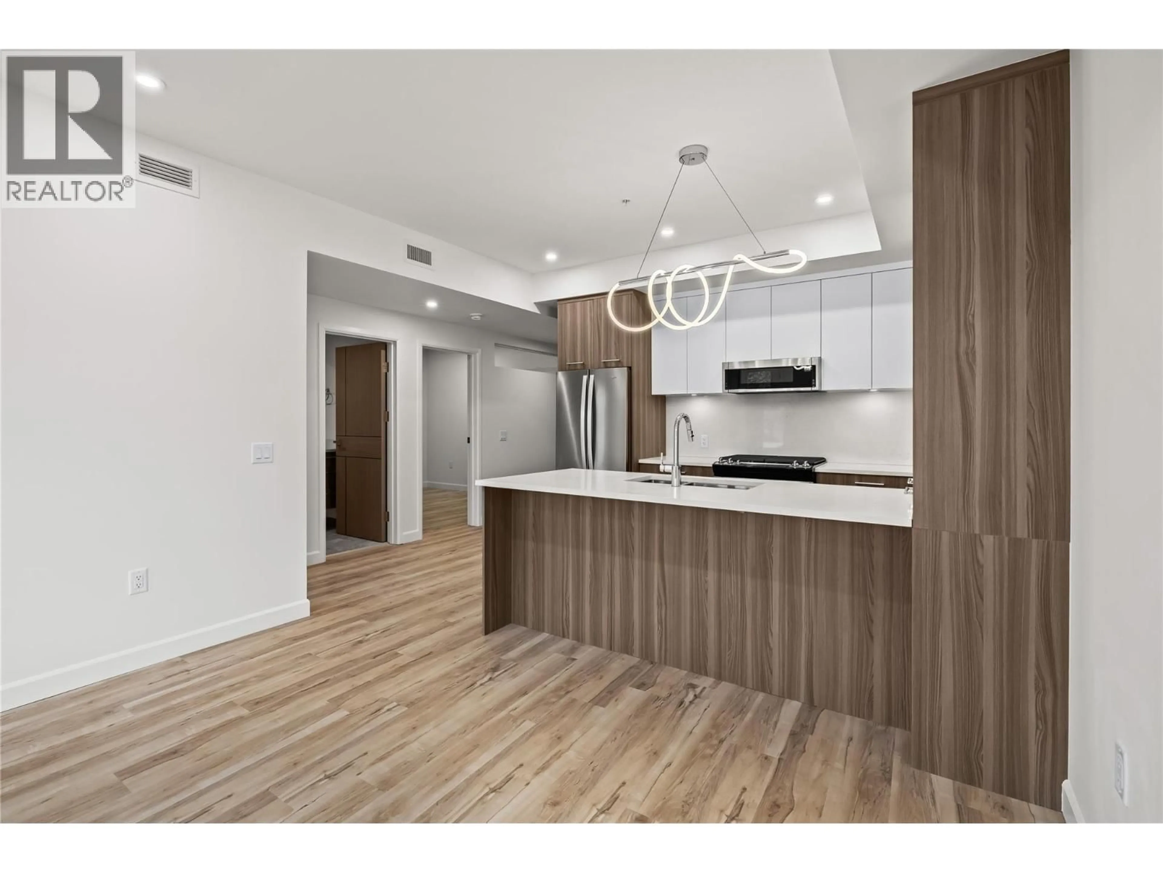 Open concept kitchen, wood/laminate floor for 305 - 630 BOYNTON PLACE, Kelowna British Columbia V1V3B8