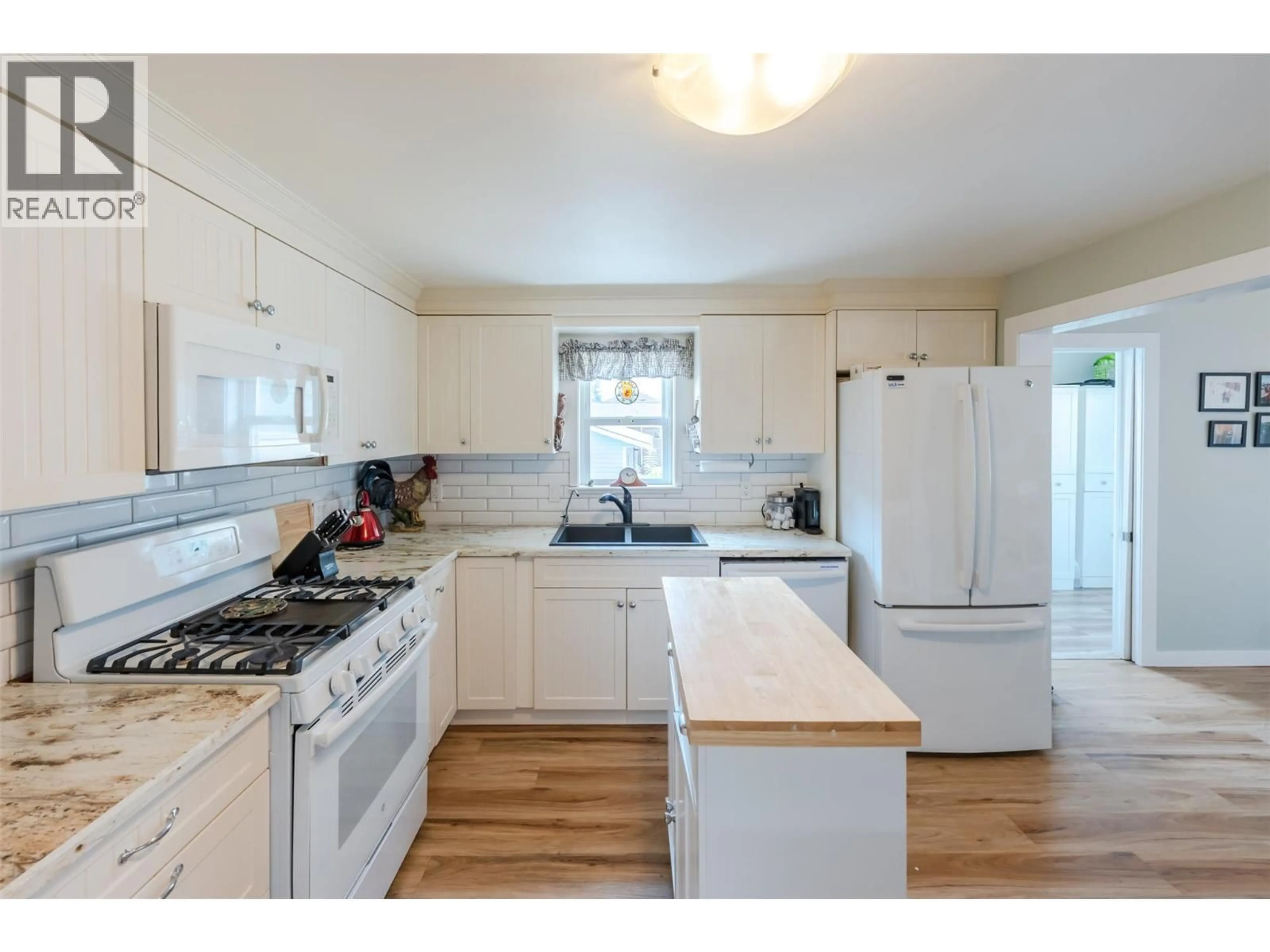Standard kitchen, wood/laminate floor for 6430 SPARTAN STREET, Oliver British Columbia V0H1T0