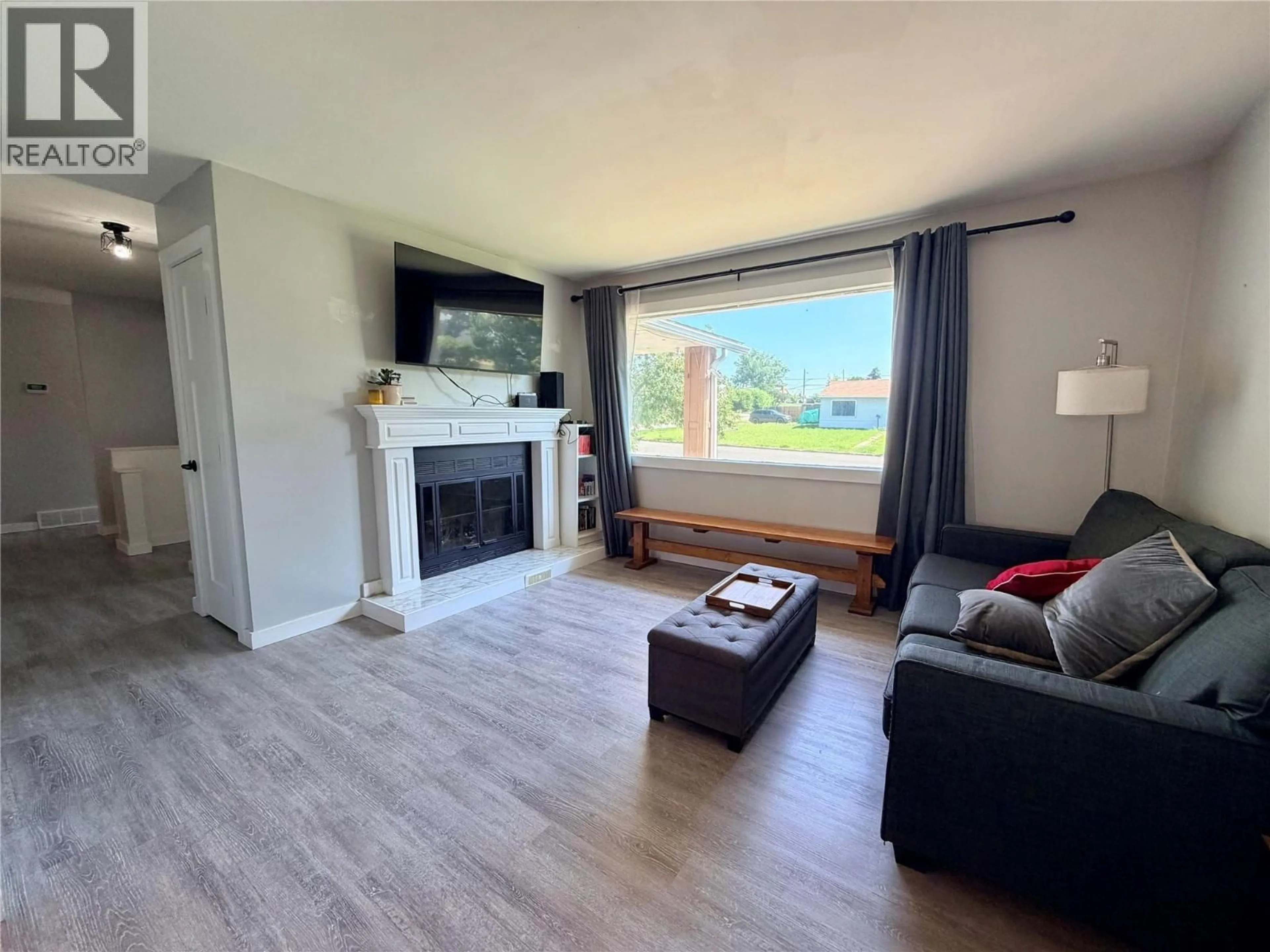Living room with furniture, wood/laminate floor for 9401 7 STREET, Dawson Creek British Columbia V1G3M7