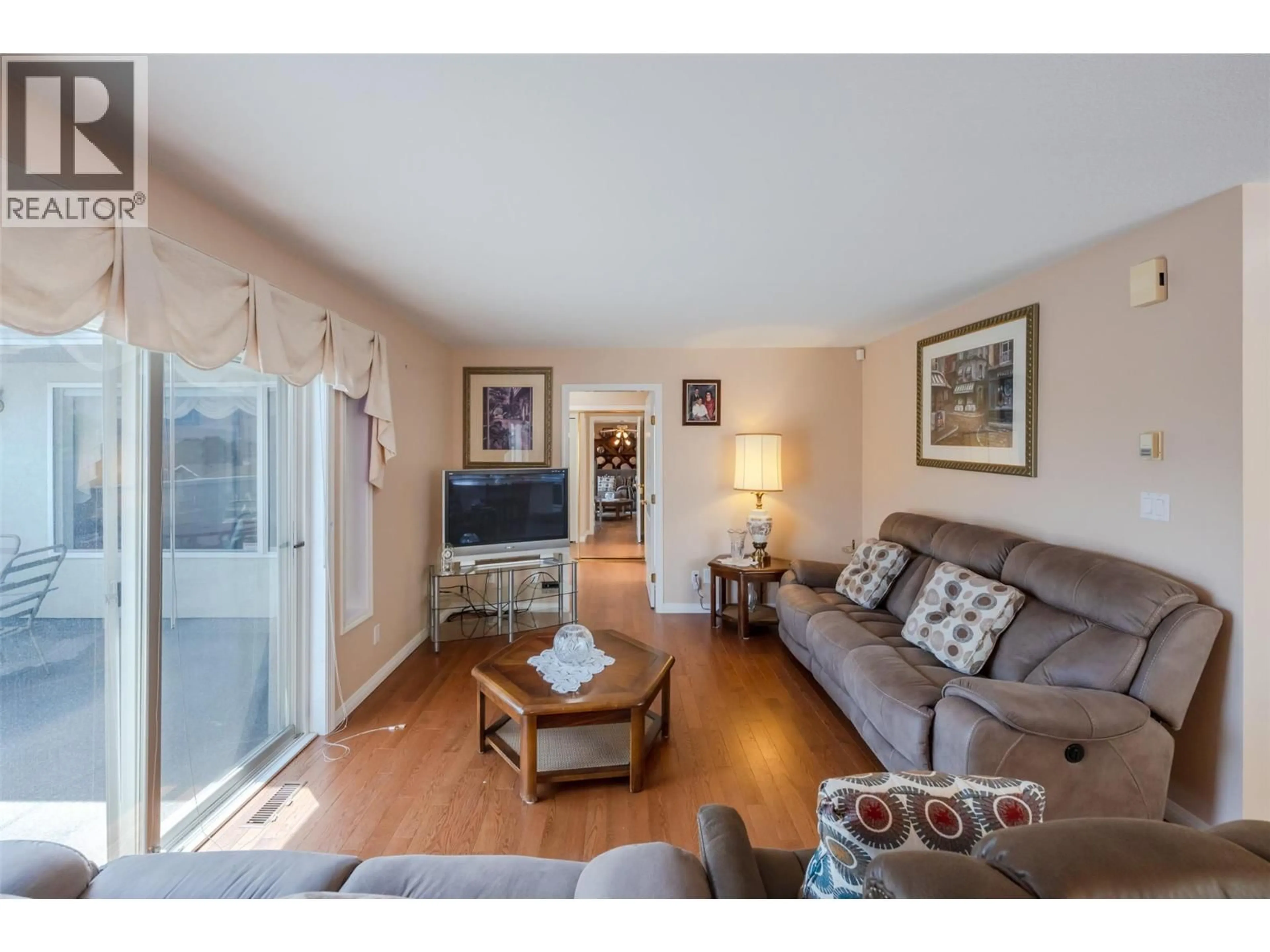 Living room with furniture, wood/laminate floor for 1 - 6163 SAINT MARTIN PLACE, Oliver British Columbia V0H1T0