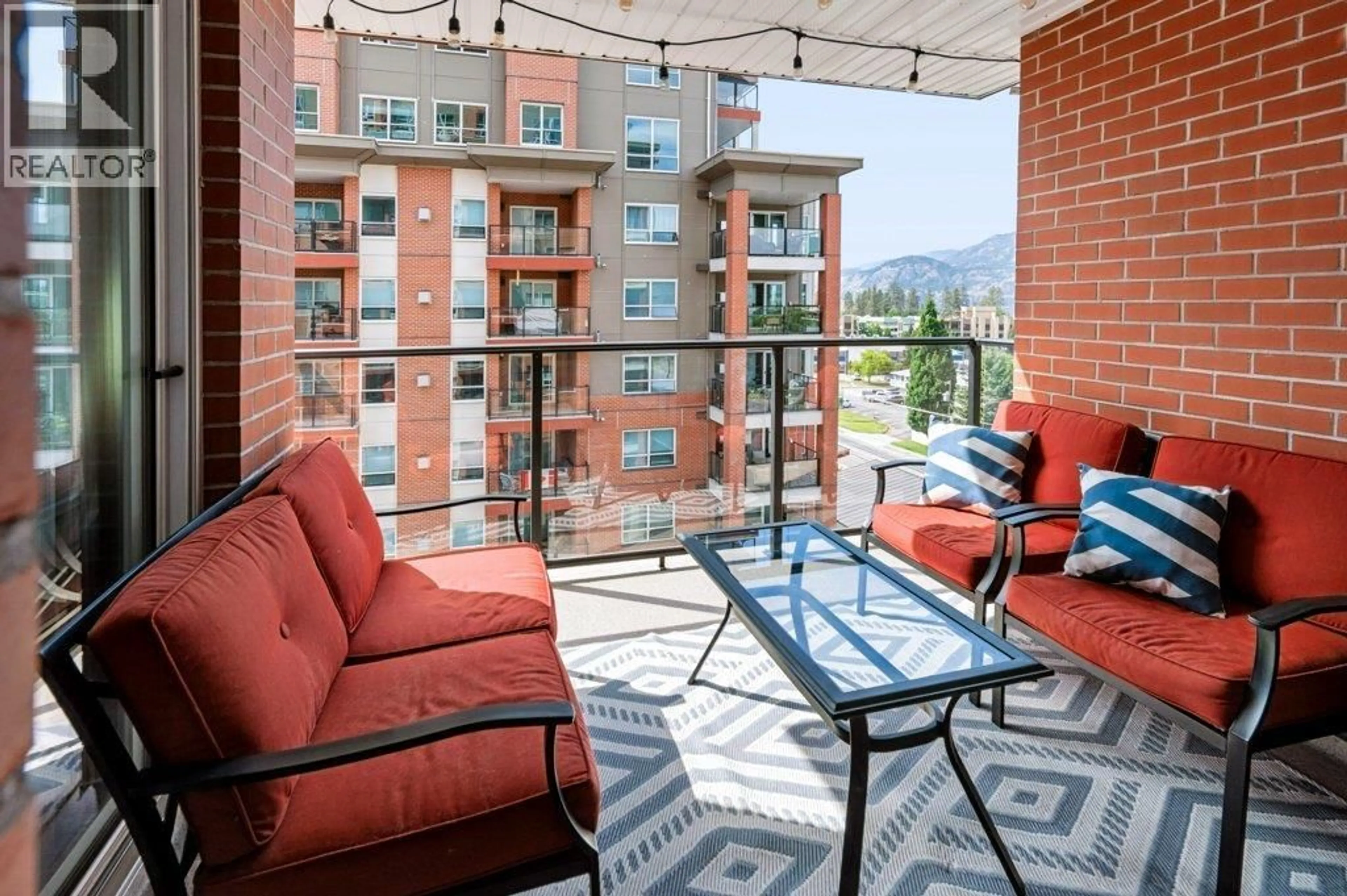 Patio, city buildings view from balcony for 706 - 3346 SKAHA LAKE ROAD, Penticton British Columbia V2A0H6