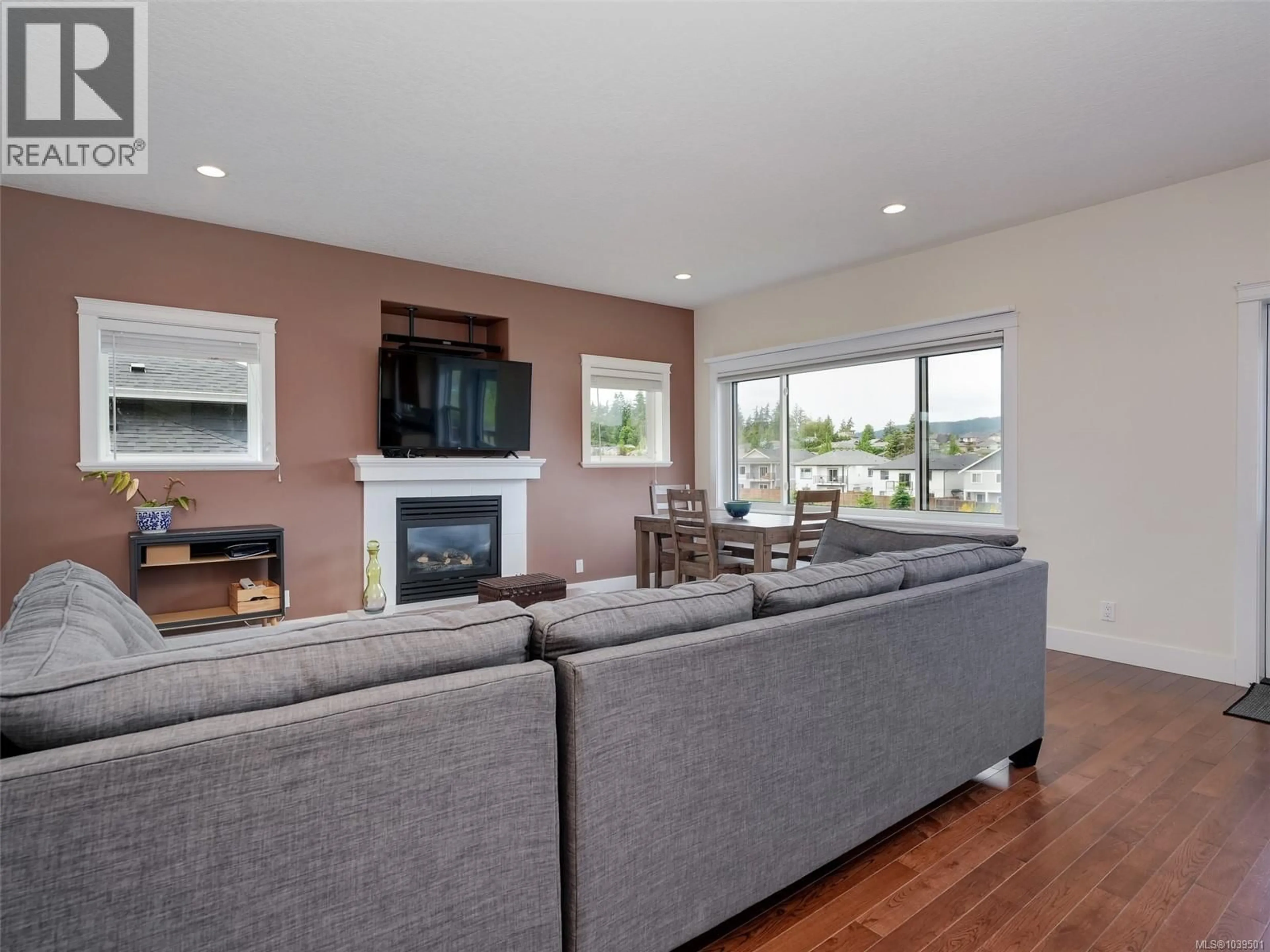 Living room with furniture, wood/laminate floor for 6742 STEEPLE CHASE, Sooke British Columbia V9Z0W3