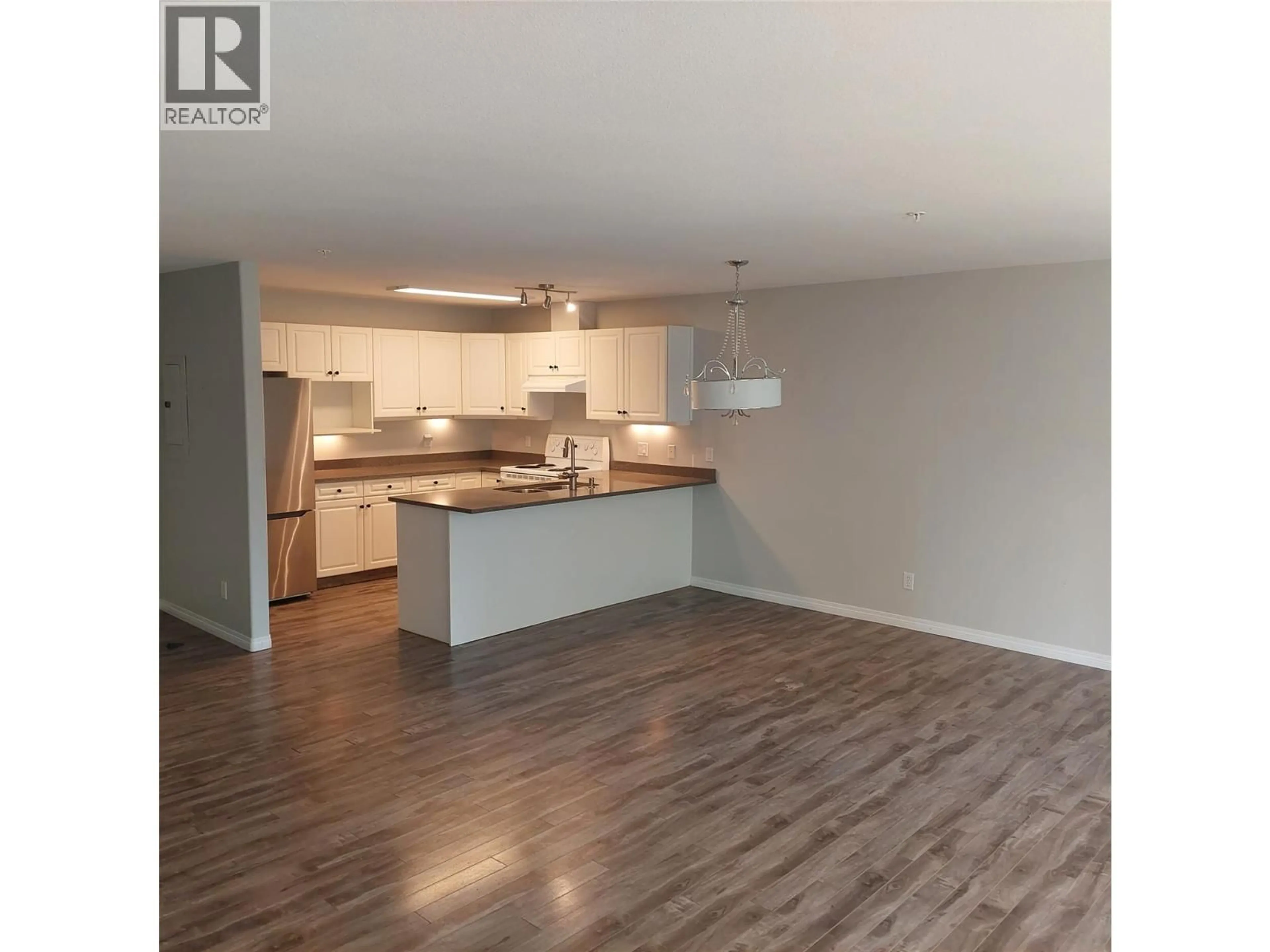 Open concept kitchen, wood/laminate floor for #206 - 1950 DURNIN ROAD, Kelowna British Columbia V1Y8K5