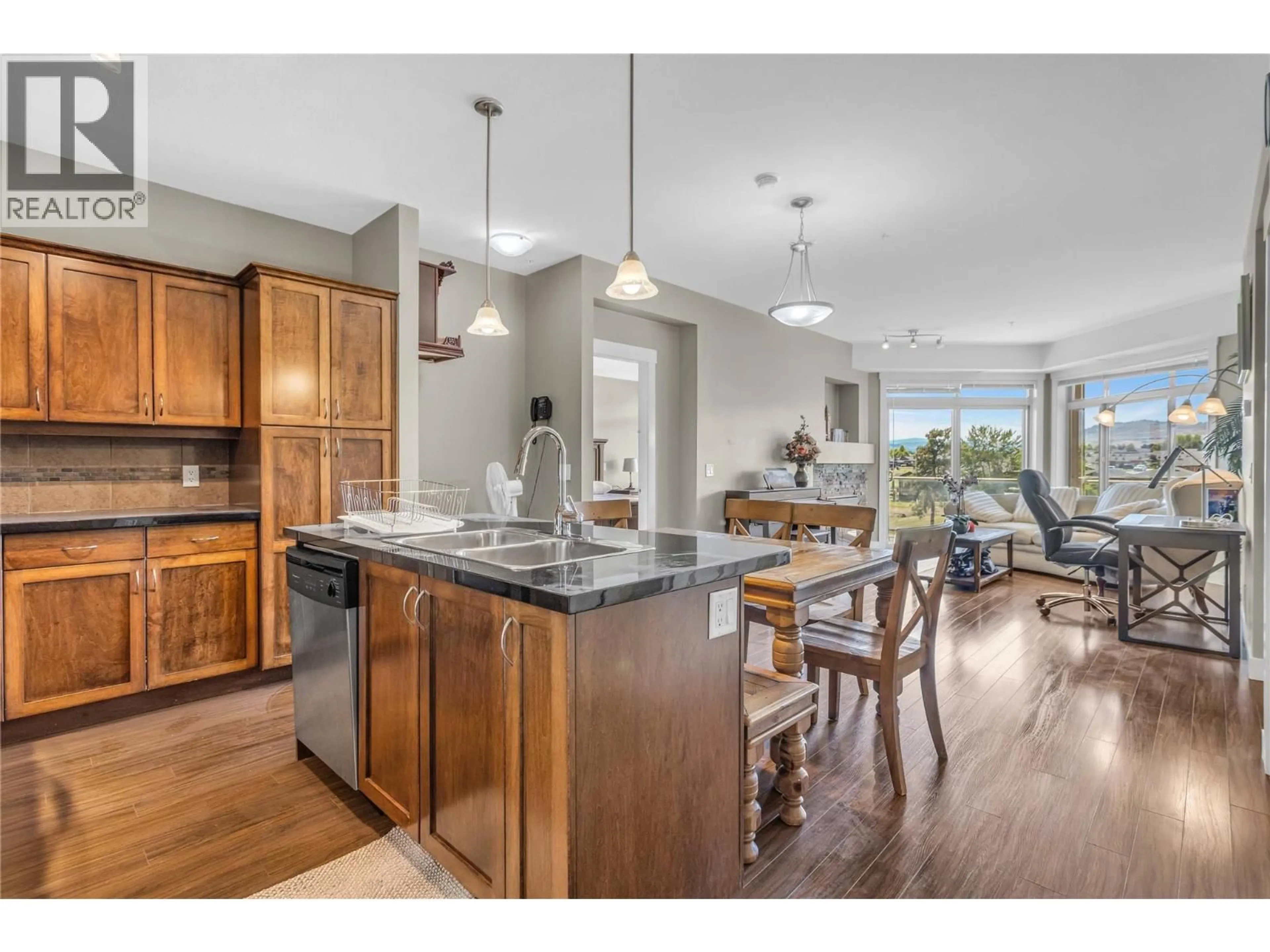 Open concept kitchen, wood/laminate floor for 306 - 3545 CARRINGTON ROAD, West Kelowna British Columbia V4T3A1