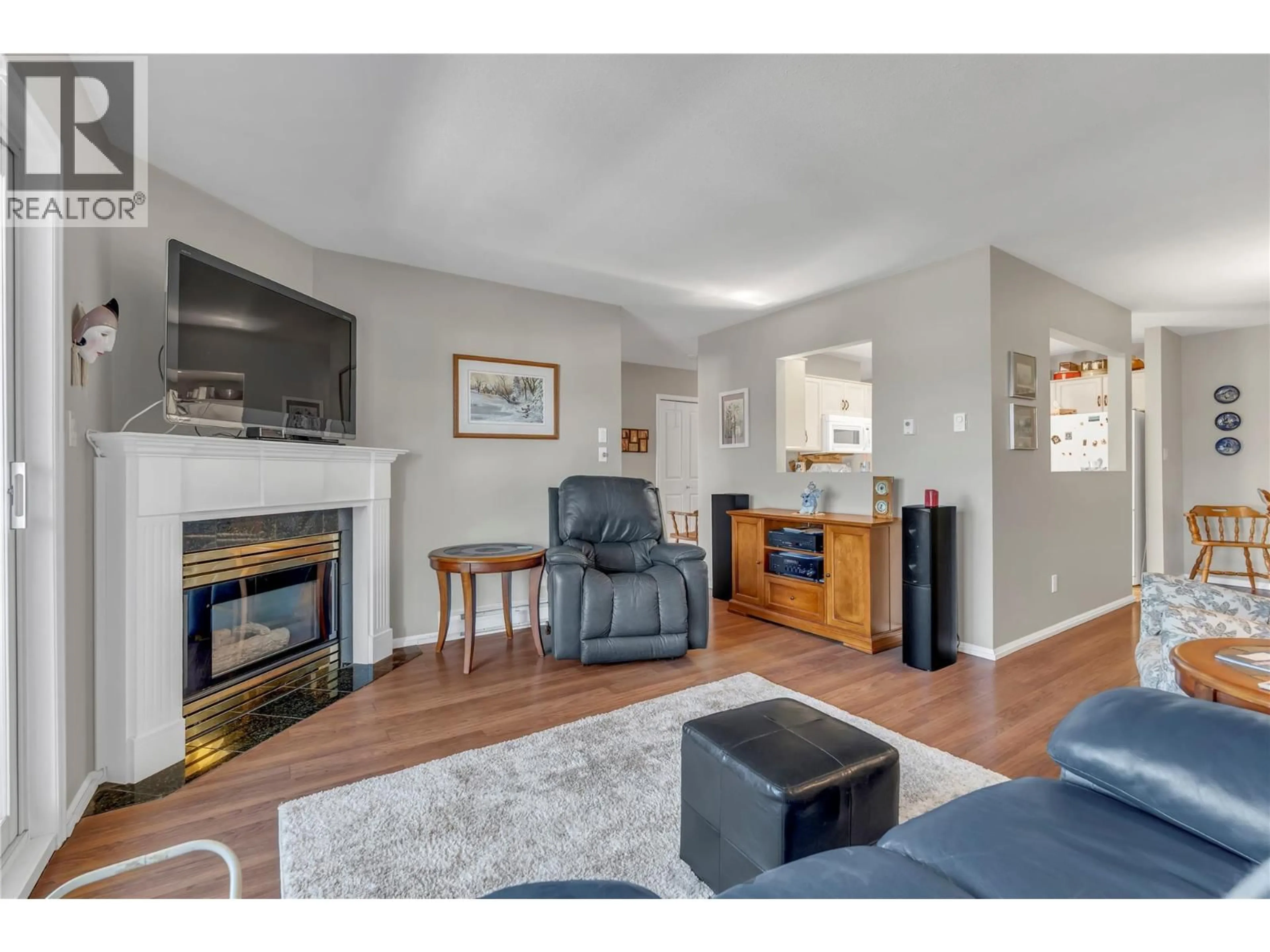Living room with furniture, wood/laminate floor for 306 - 8907 PINEO COURT, Summerland British Columbia V0H1Z5