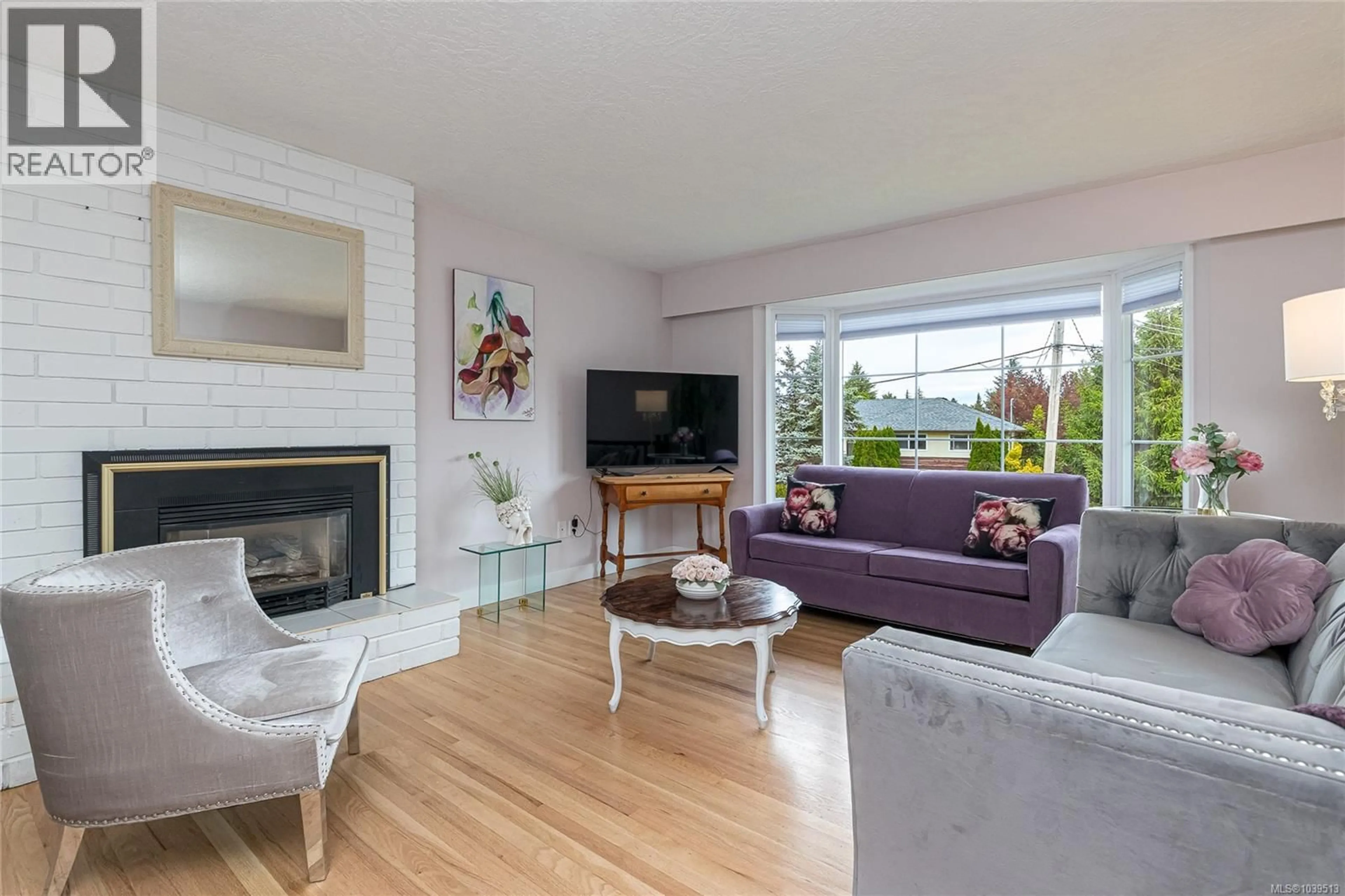 Living room with furniture, wood/laminate floor for 3881 OLIVIA PLACE, Saanich British Columbia V8P4T3