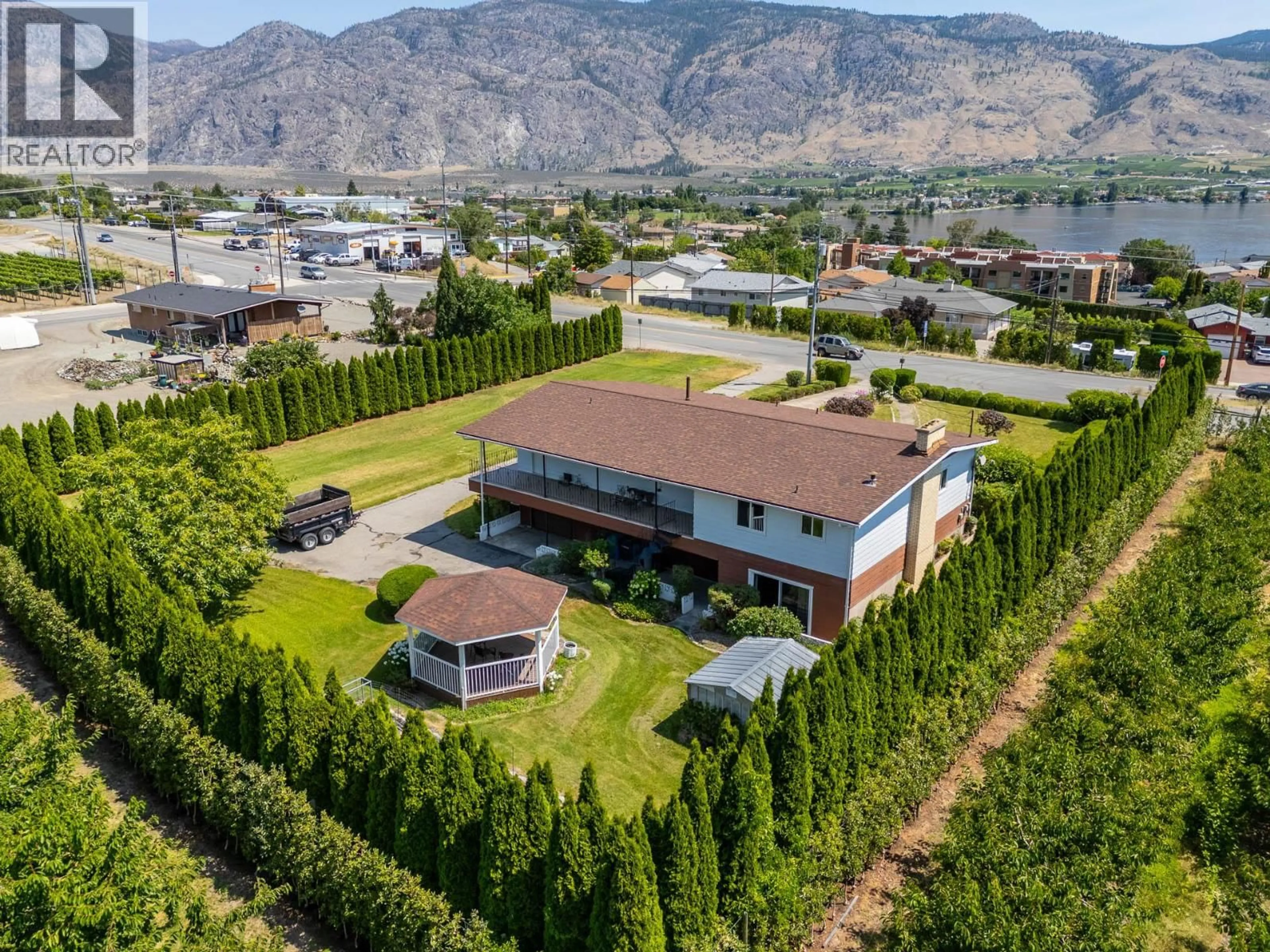A pic from outside/outdoor area/front of a property/back of a property/a pic from drone, mountain view for 6012 107TH STREET, Osoyoos British Columbia V0H1V4