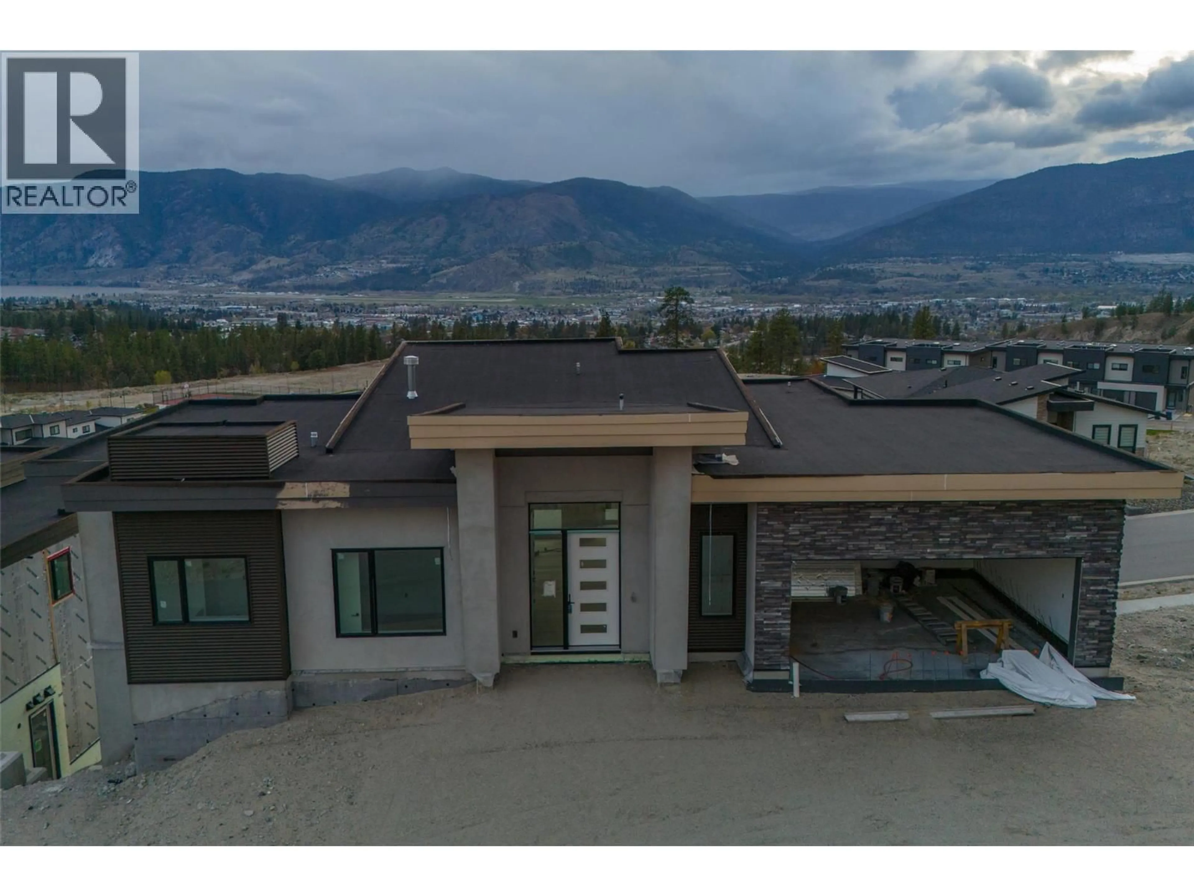 A pic from outside/outdoor area/front of a property/back of a property/a pic from drone, mountain view for 1092 ANTLER DRIVE, Penticton British Columbia V2A0J8