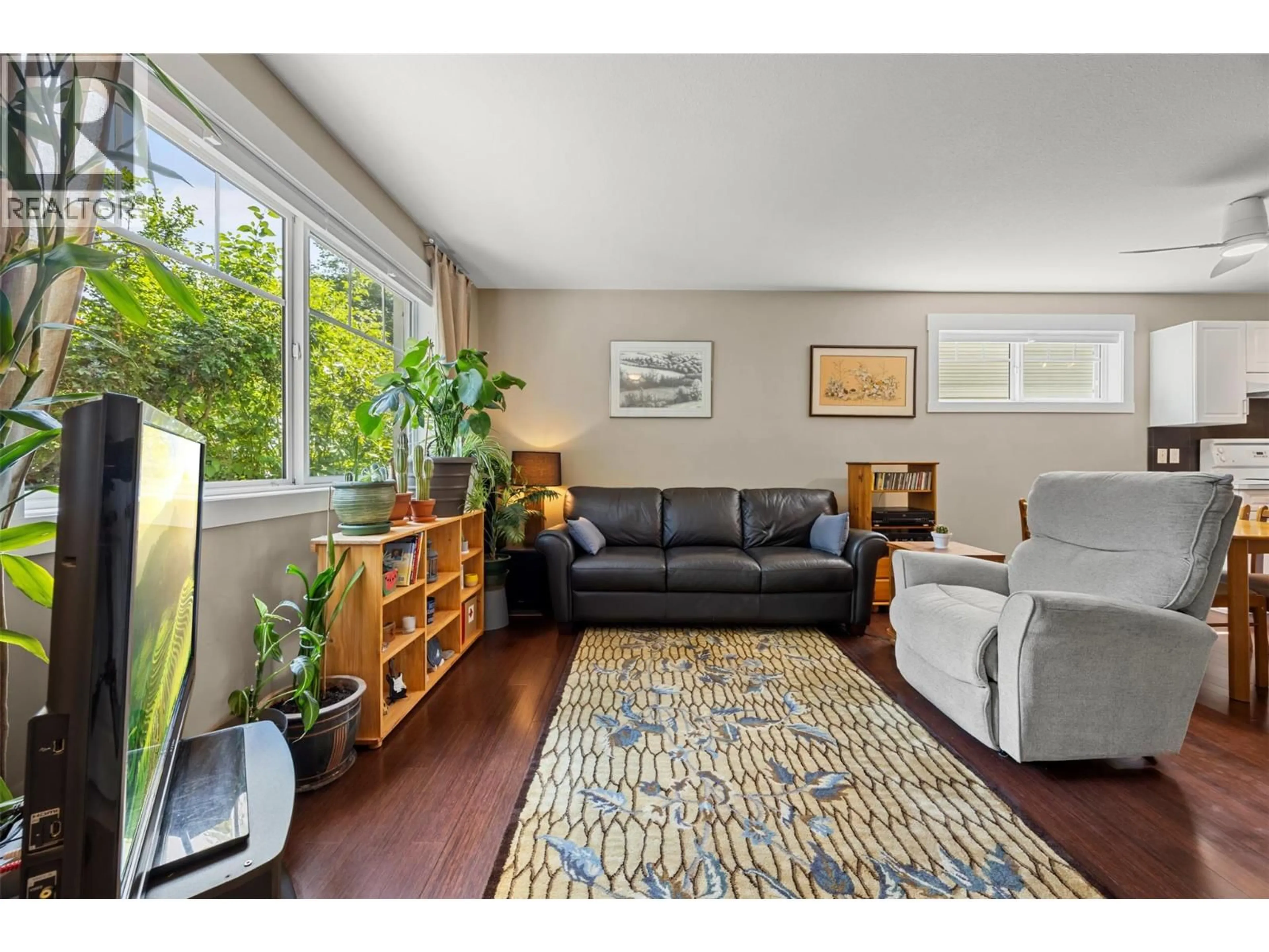 Living room with furniture, wood/laminate floor for 108 - 1380 DILWORTH CRESCENT, Kelowna British Columbia V1Y4M5