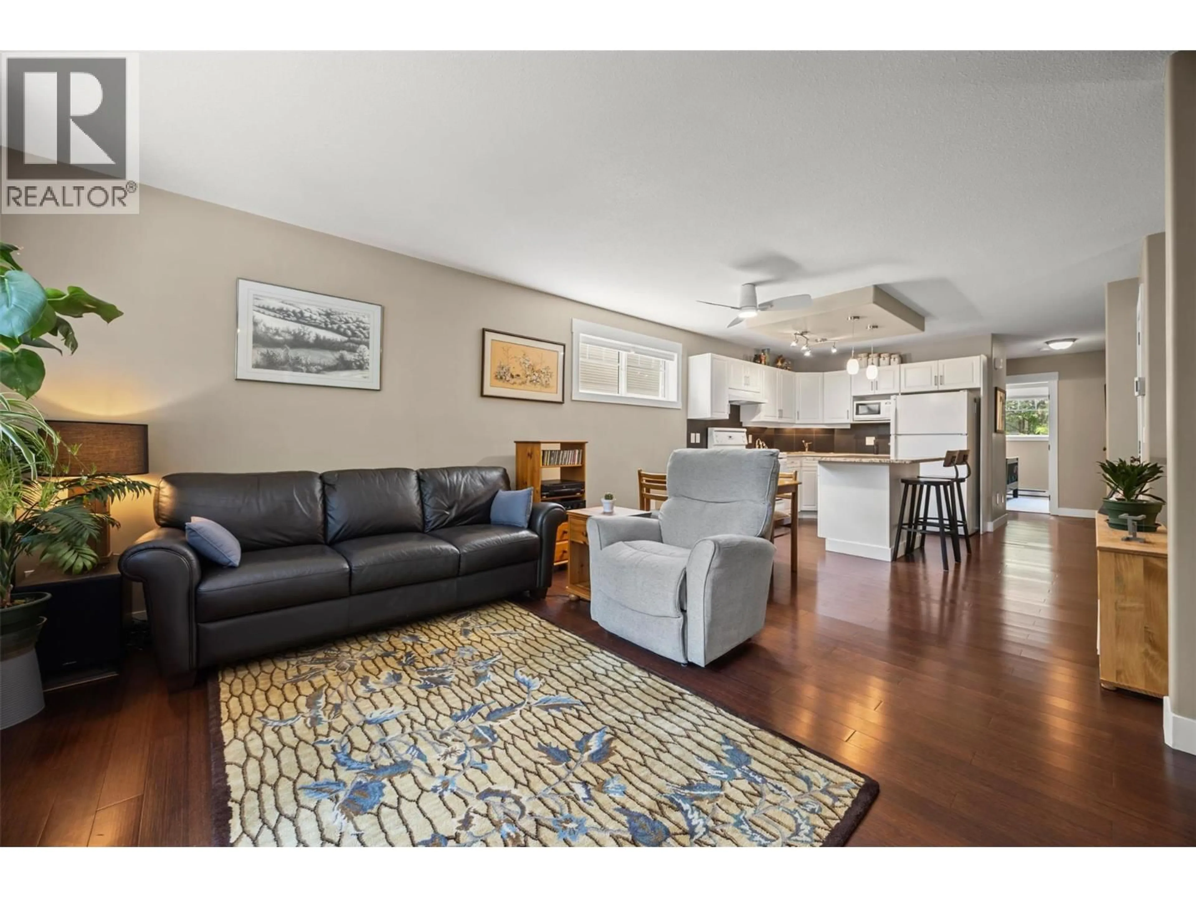 Living room with furniture, wood/laminate floor for 108 - 1380 DILWORTH CRESCENT, Kelowna British Columbia V1Y4M5