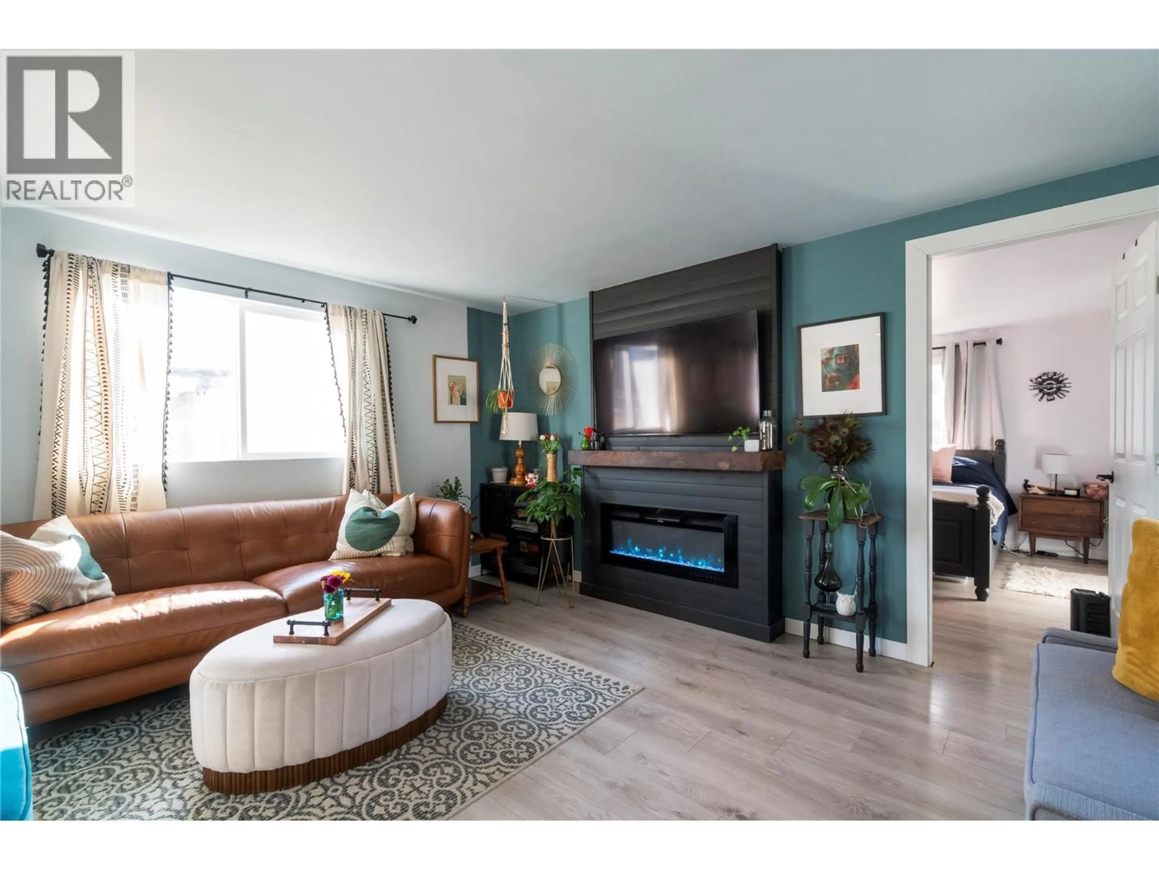 Living room with furniture, wood/laminate floor for 5131 69 AVENUE NORTHEAST, Canoe British Columbia V0E1K0