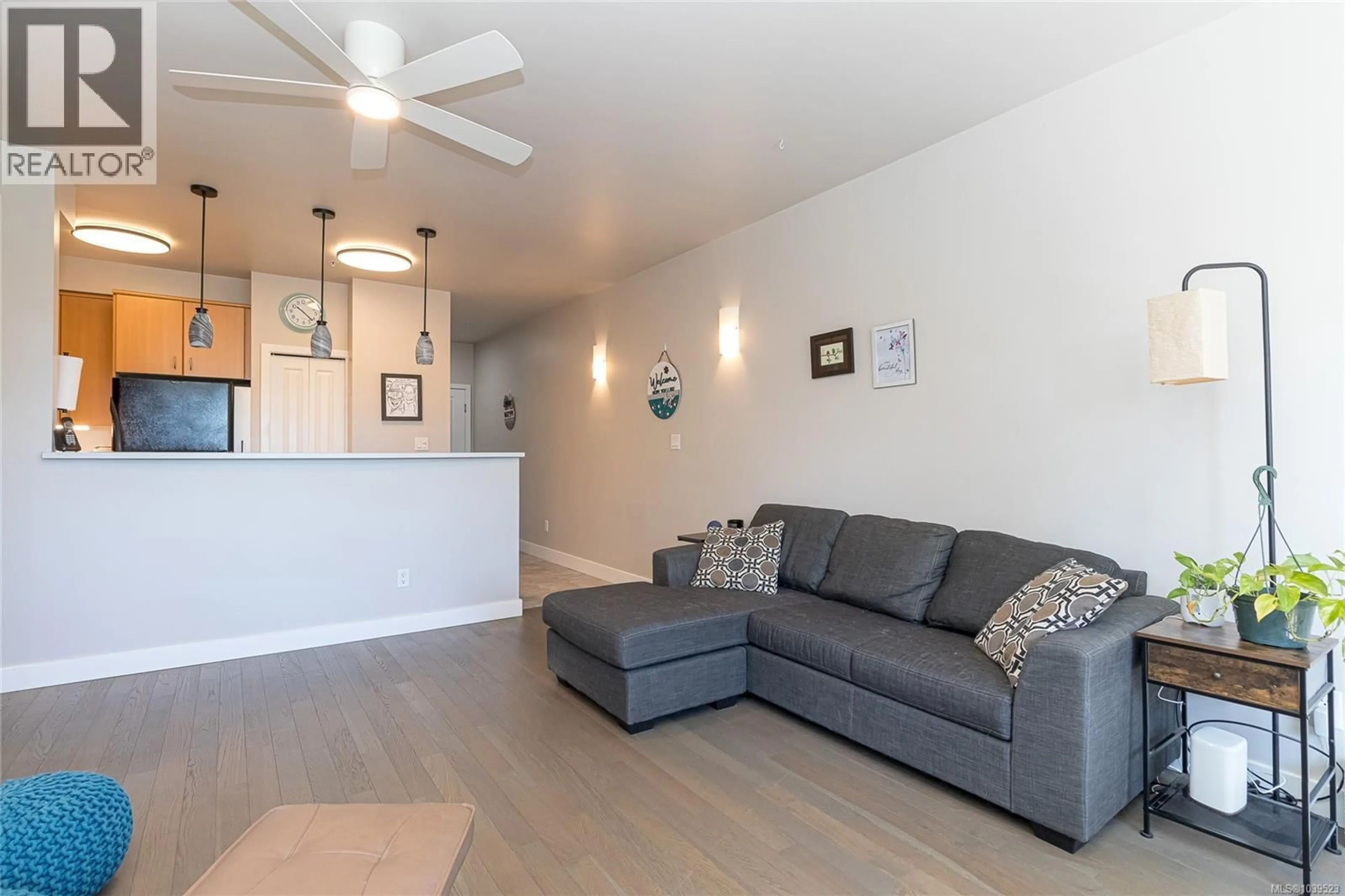 Living room with furniture, wood/laminate floor for 308E - 1115 CRAIGFLOWER ROAD, Esquimalt British Columbia V9A7R1