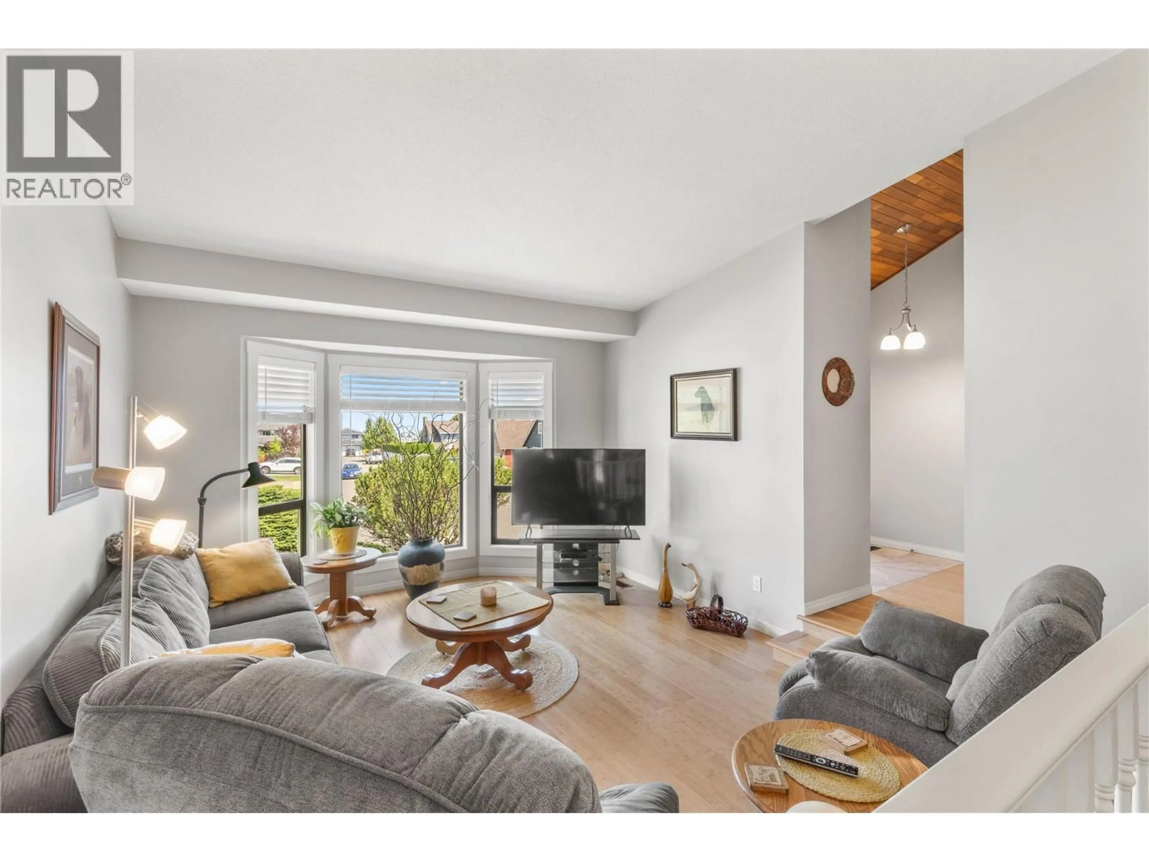 Living room with furniture, wood/laminate floor for 2299 AINSLIE PLACE, Kamloops British Columbia V1S1H3