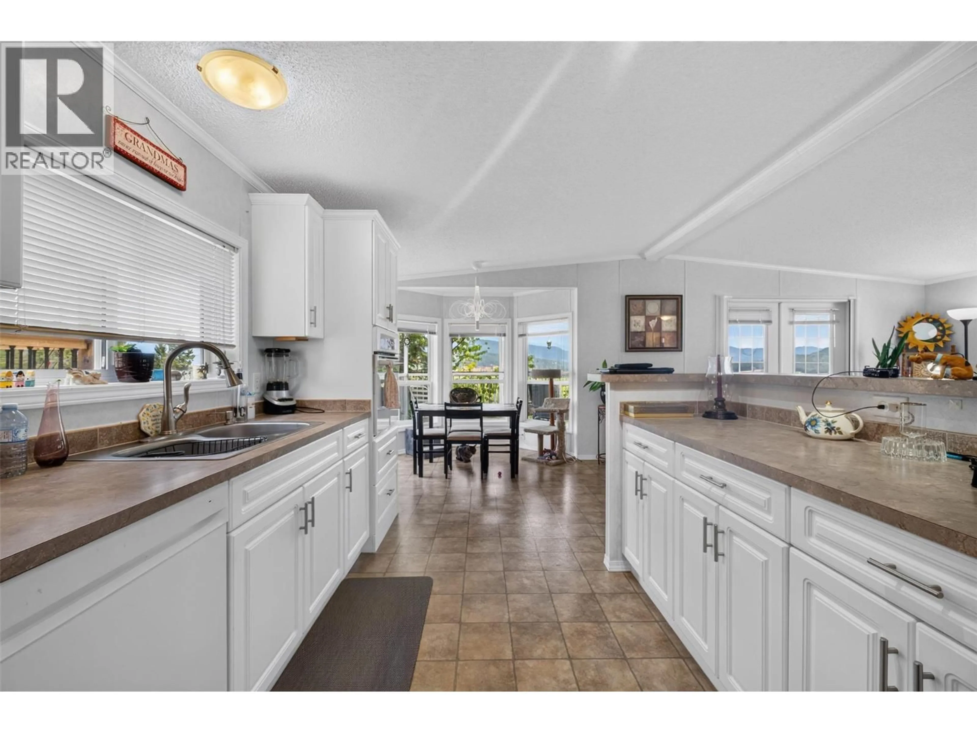 Open concept kitchen, ceramic/tile floor for 32 - 1885 TAPPEN NOTCH HILL ROAD, Tappen British Columbia V0E2X3