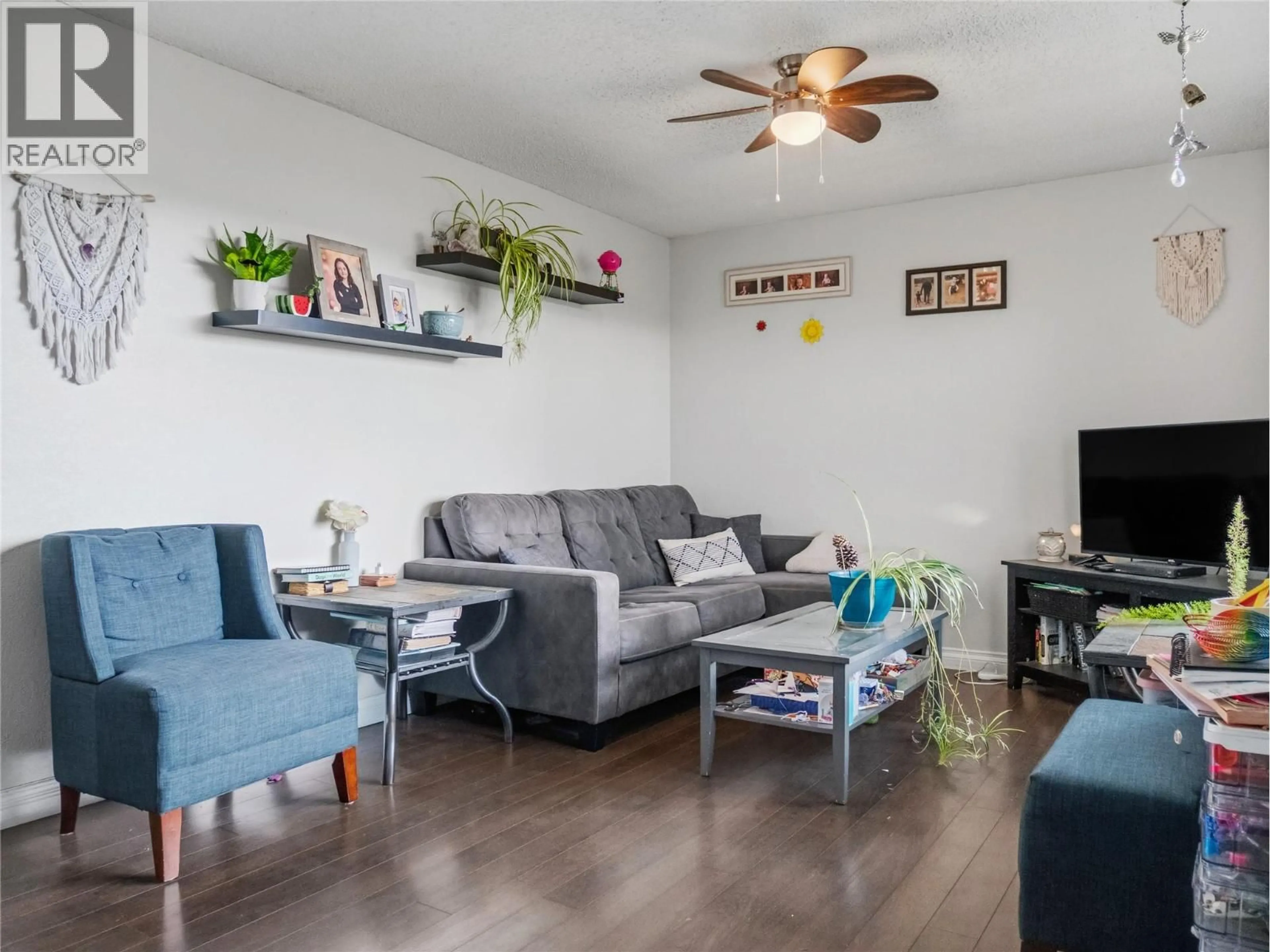 Living room with furniture, wood/laminate floor for 408 96A AVENUE, Dawson Creek British Columbia V1G1M4