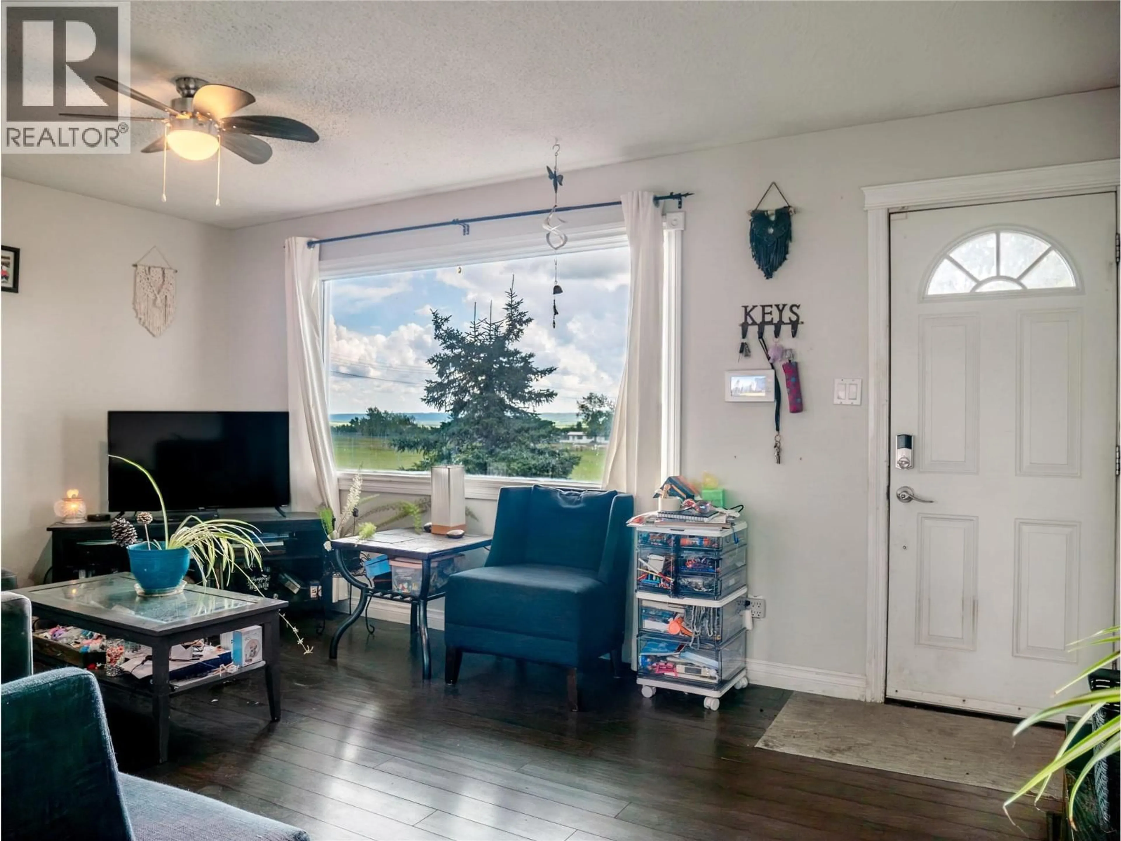 Living room with furniture, wood/laminate floor for 408 96A AVENUE, Dawson Creek British Columbia V1G1M4