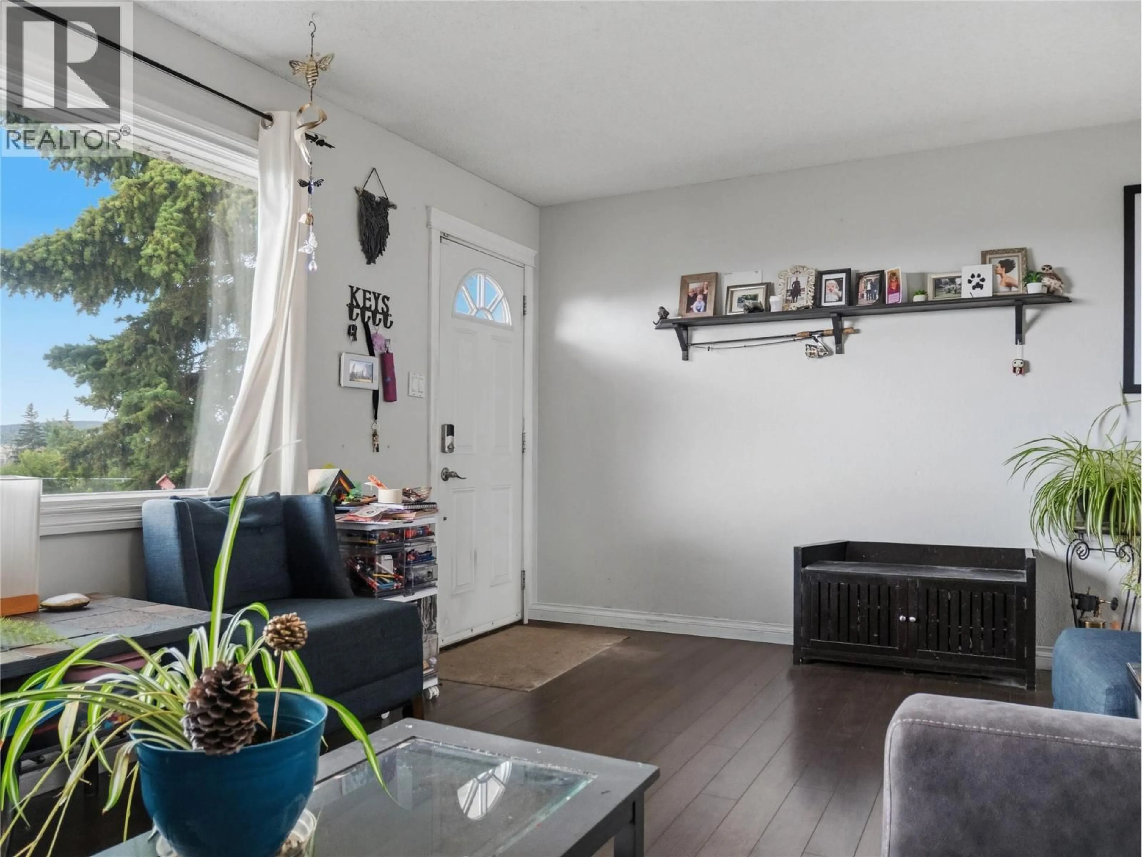 Living room with furniture, wood/laminate floor for 408 96A AVENUE, Dawson Creek British Columbia V1G1M4