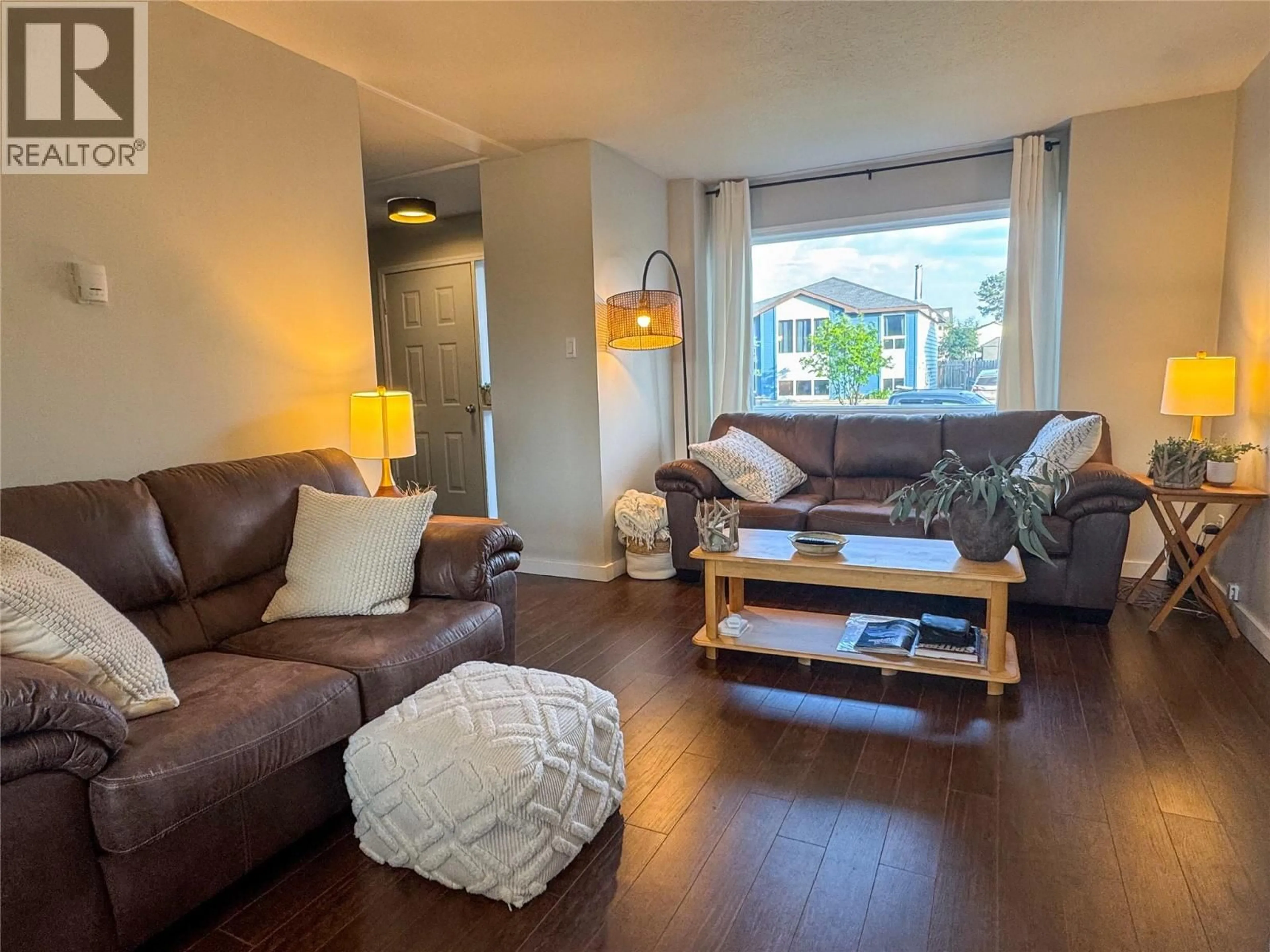 Living room with furniture, wood/laminate floor for 175 VALLEYVIEW CRESCENT, Tumbler Ridge British Columbia V0C2W0